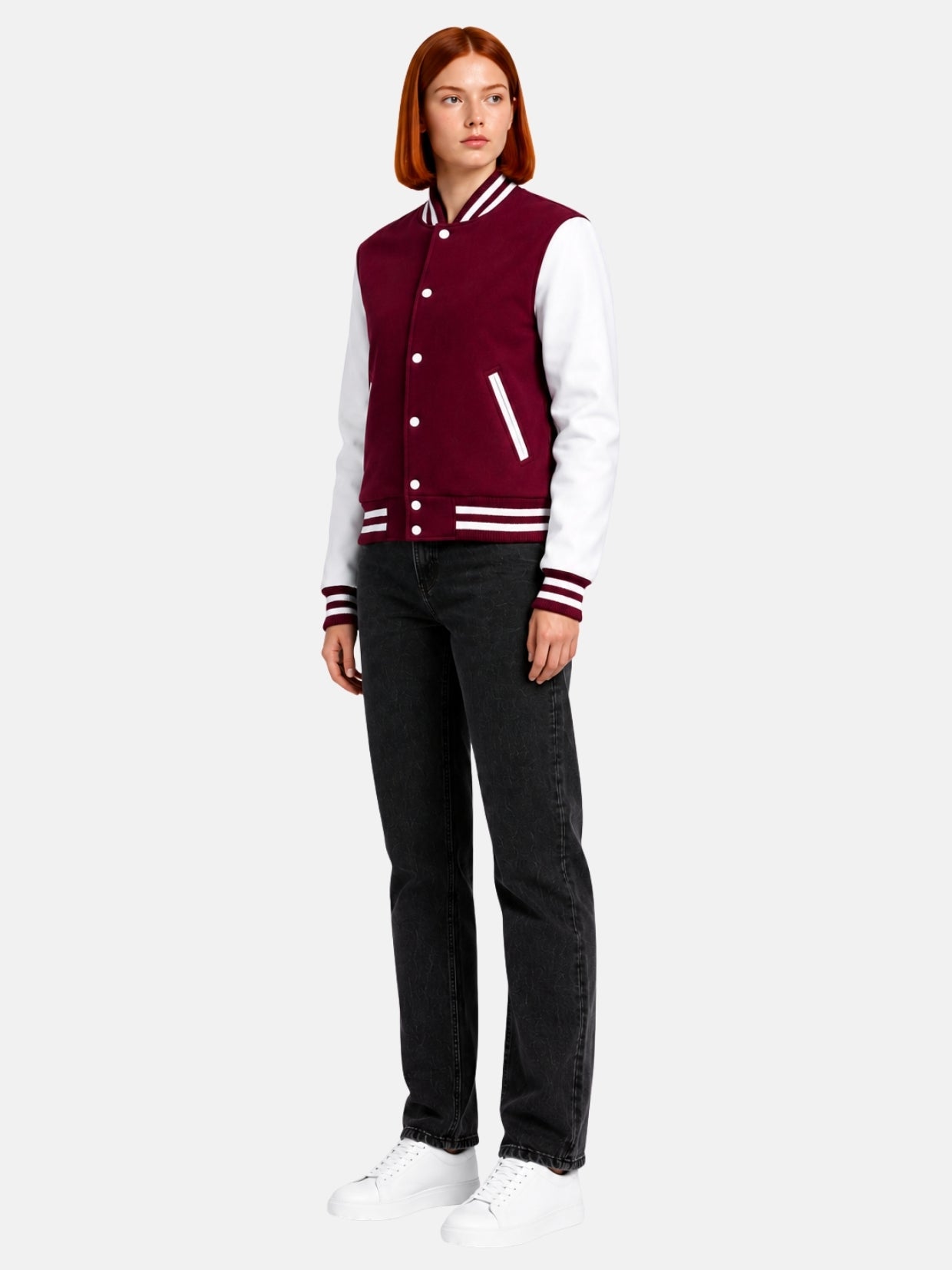 Full-length view of female model in burgundy and white varsity jacket with dark jeans