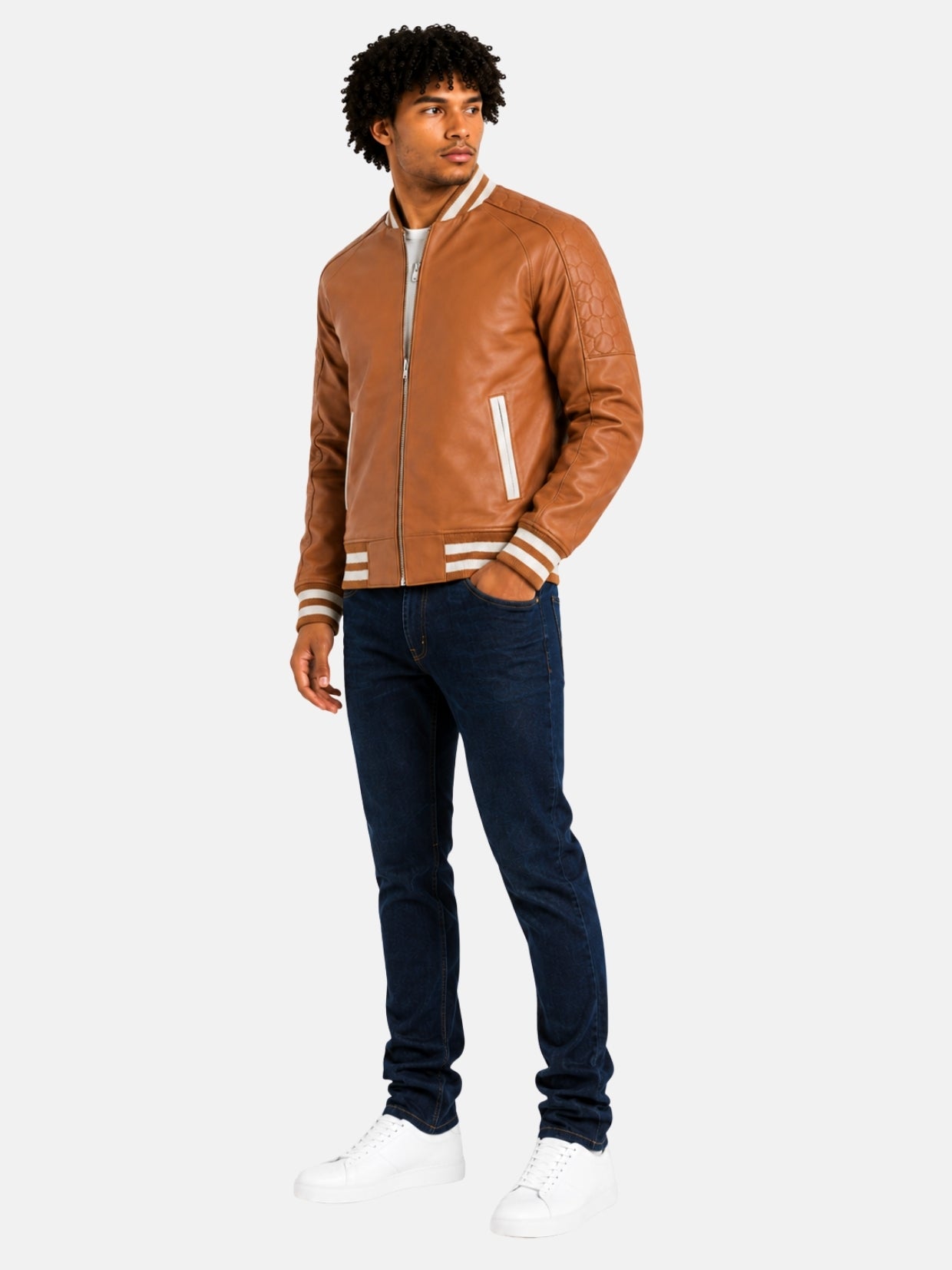 Full-length look with camel leather letterman jacket, dark denim and white sneakers
