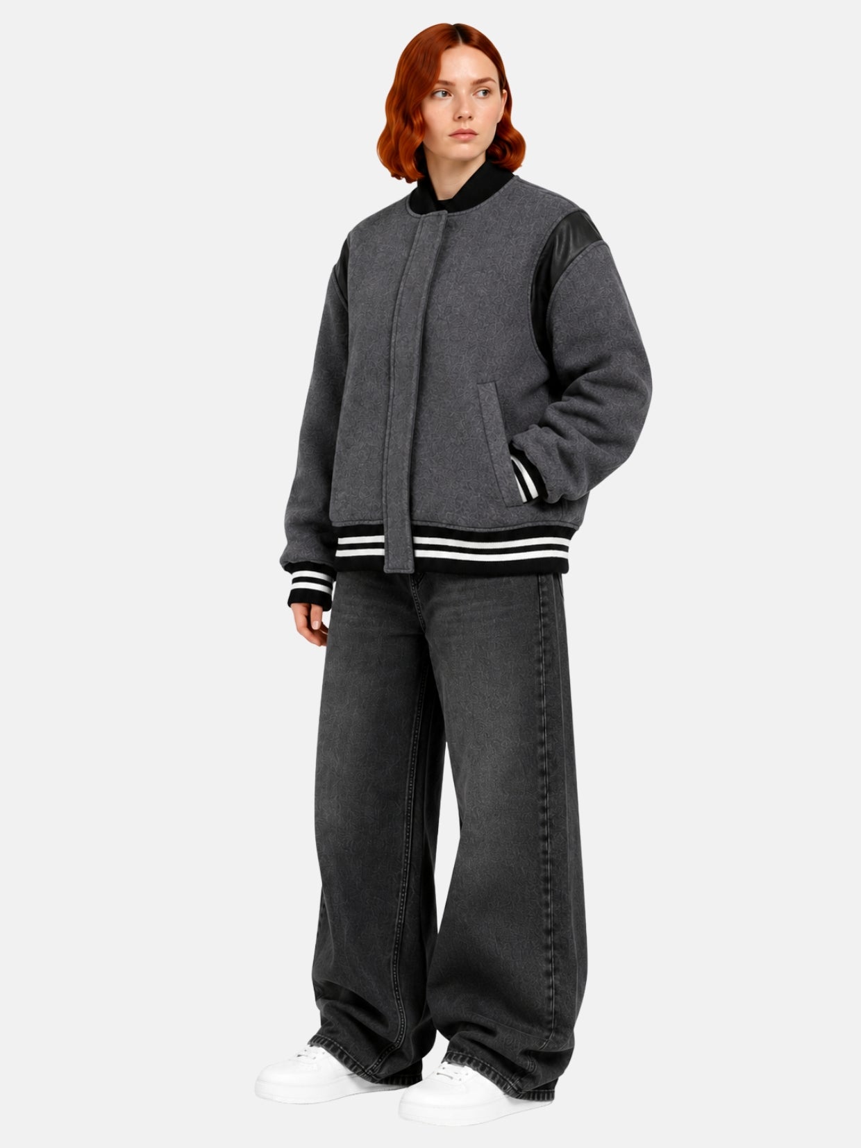 Angled full-body view of oversized charcoal wool and leather varsity jacket