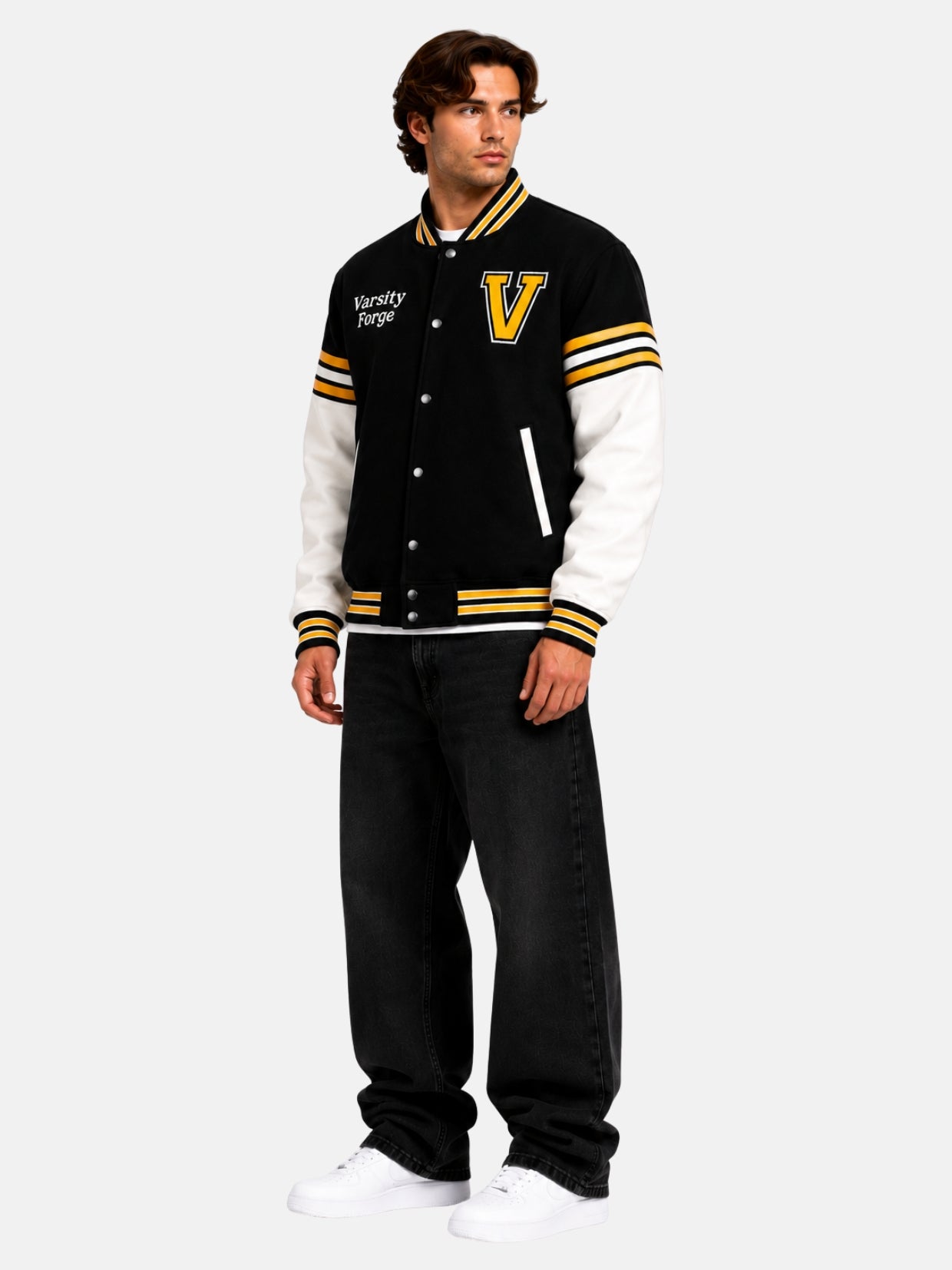 Model in oversized letterman jacket with chenille V patch, striped sleeve bands and baggy jeans