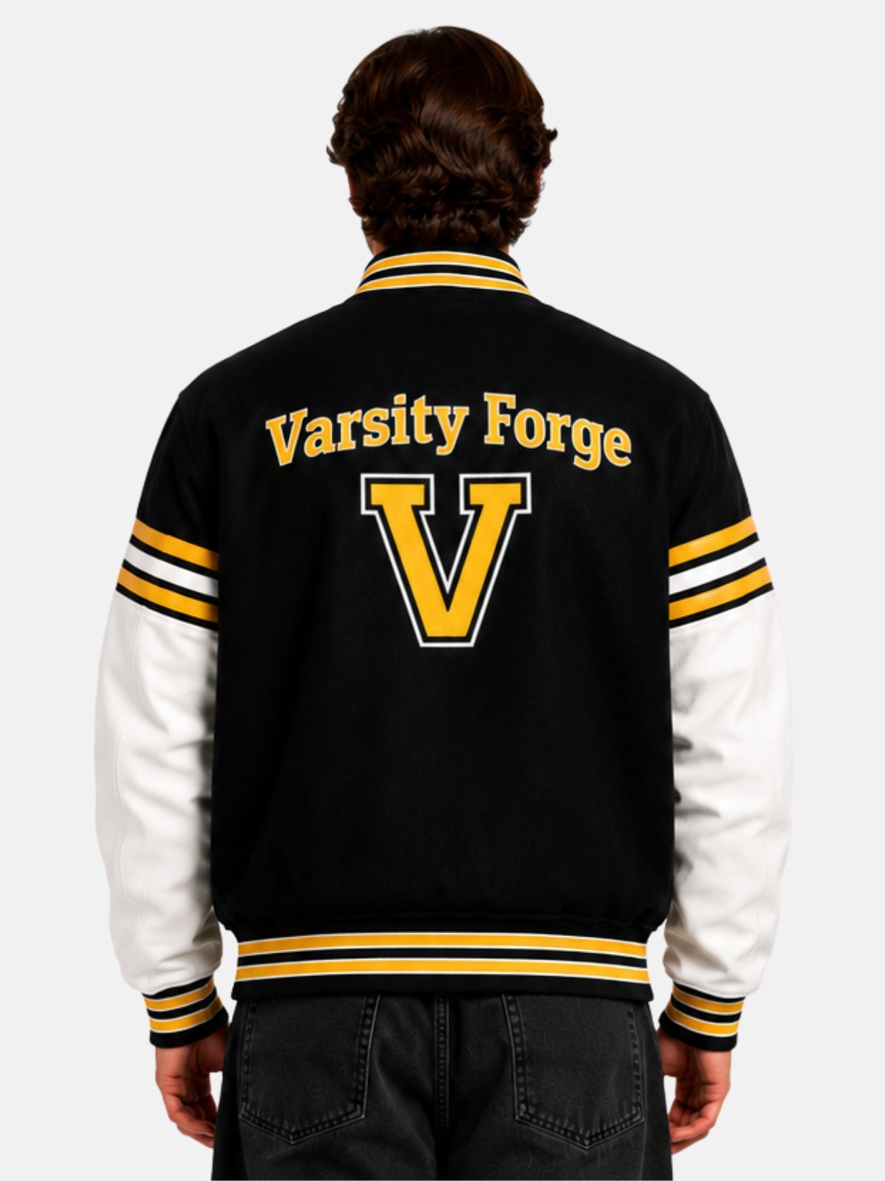 Model showing back of black varsity jacket with arched Varsity Forge lettering and gold V