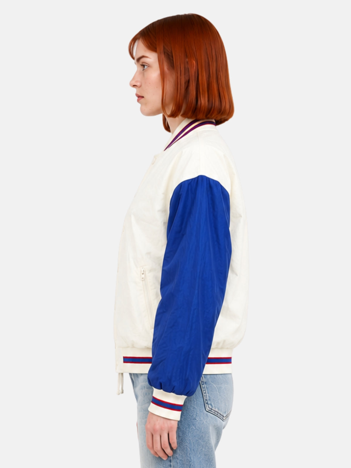 Side profile of cream windbreaker jacket showing blue raglan sleeve