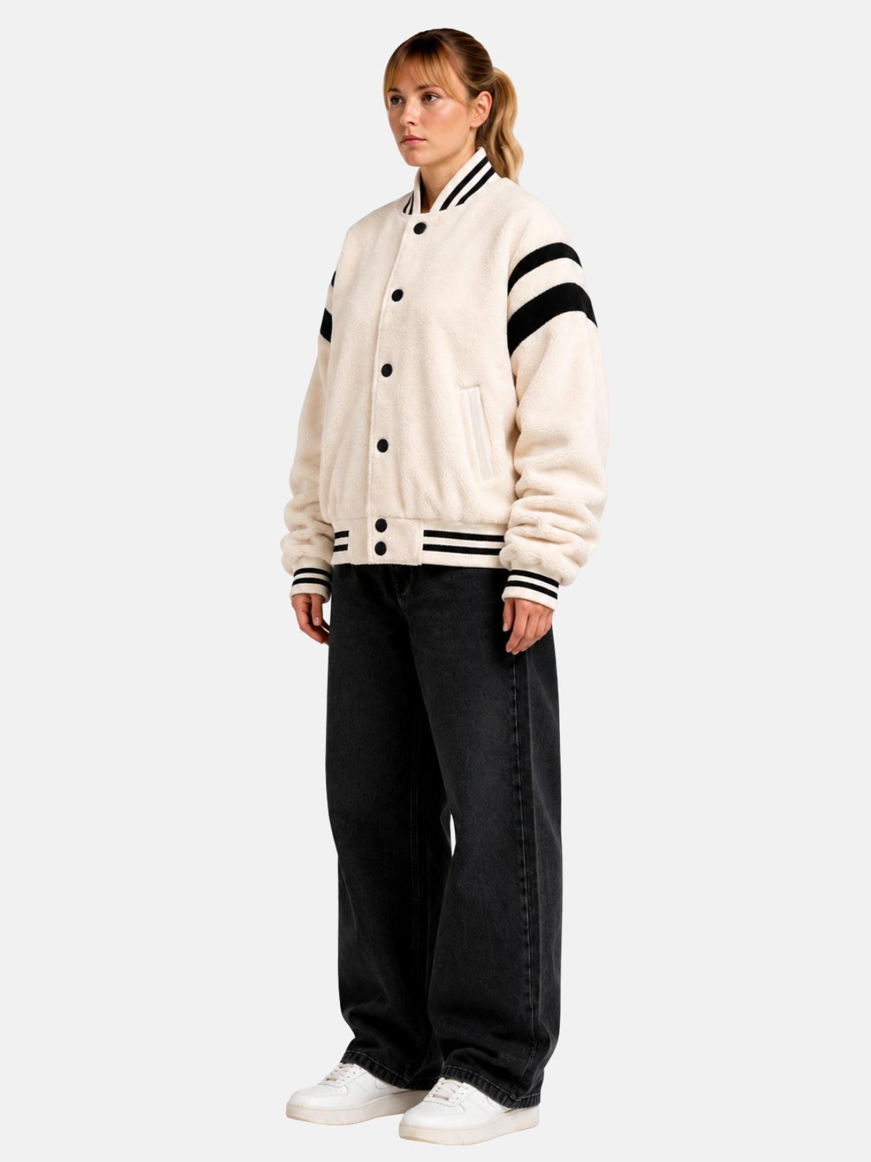 Angled full-body view of oversized cream sherpa letterman jacket