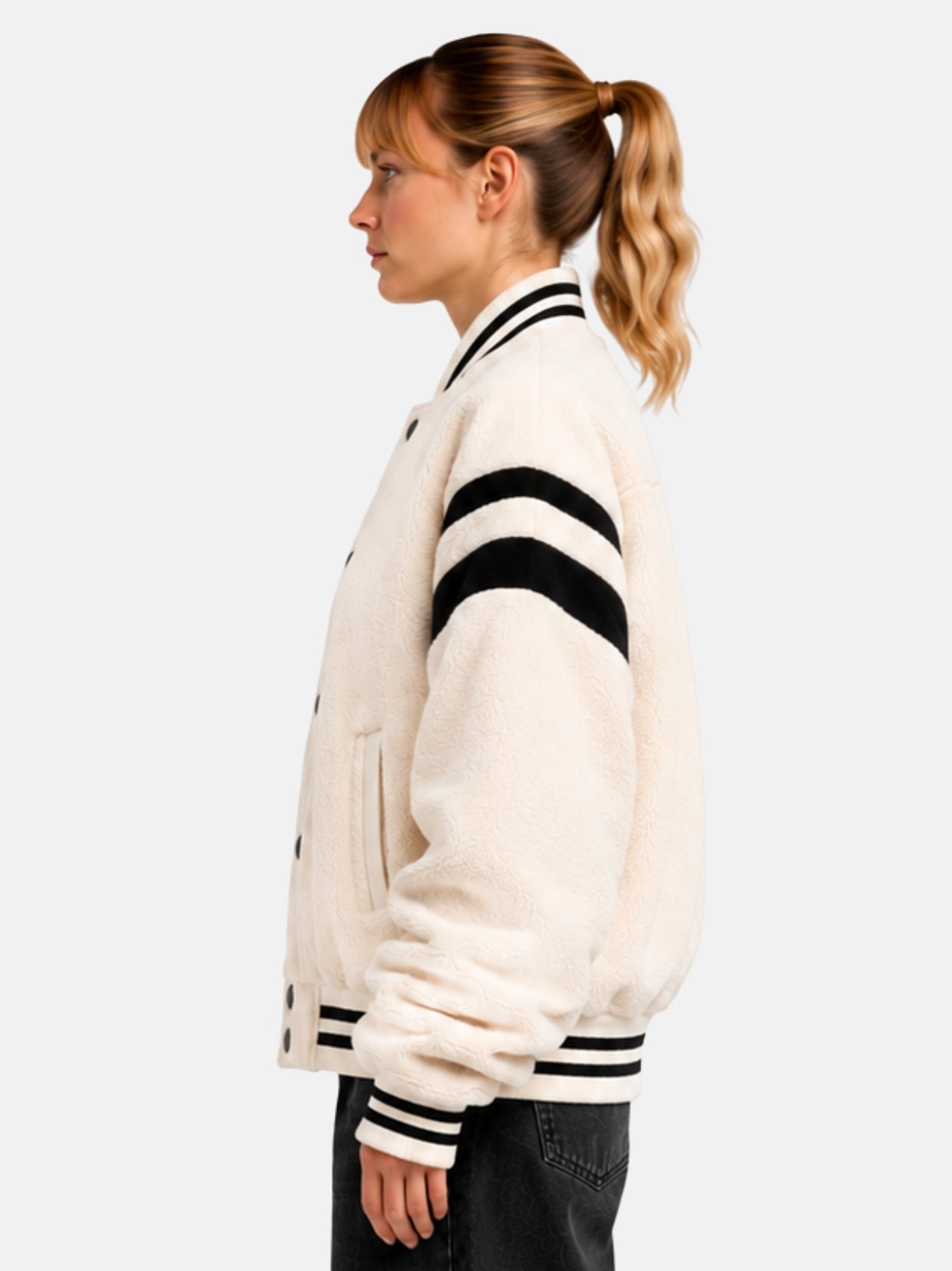 Side profile of cream sherpa varsity jacket showing sleeve stripe detail