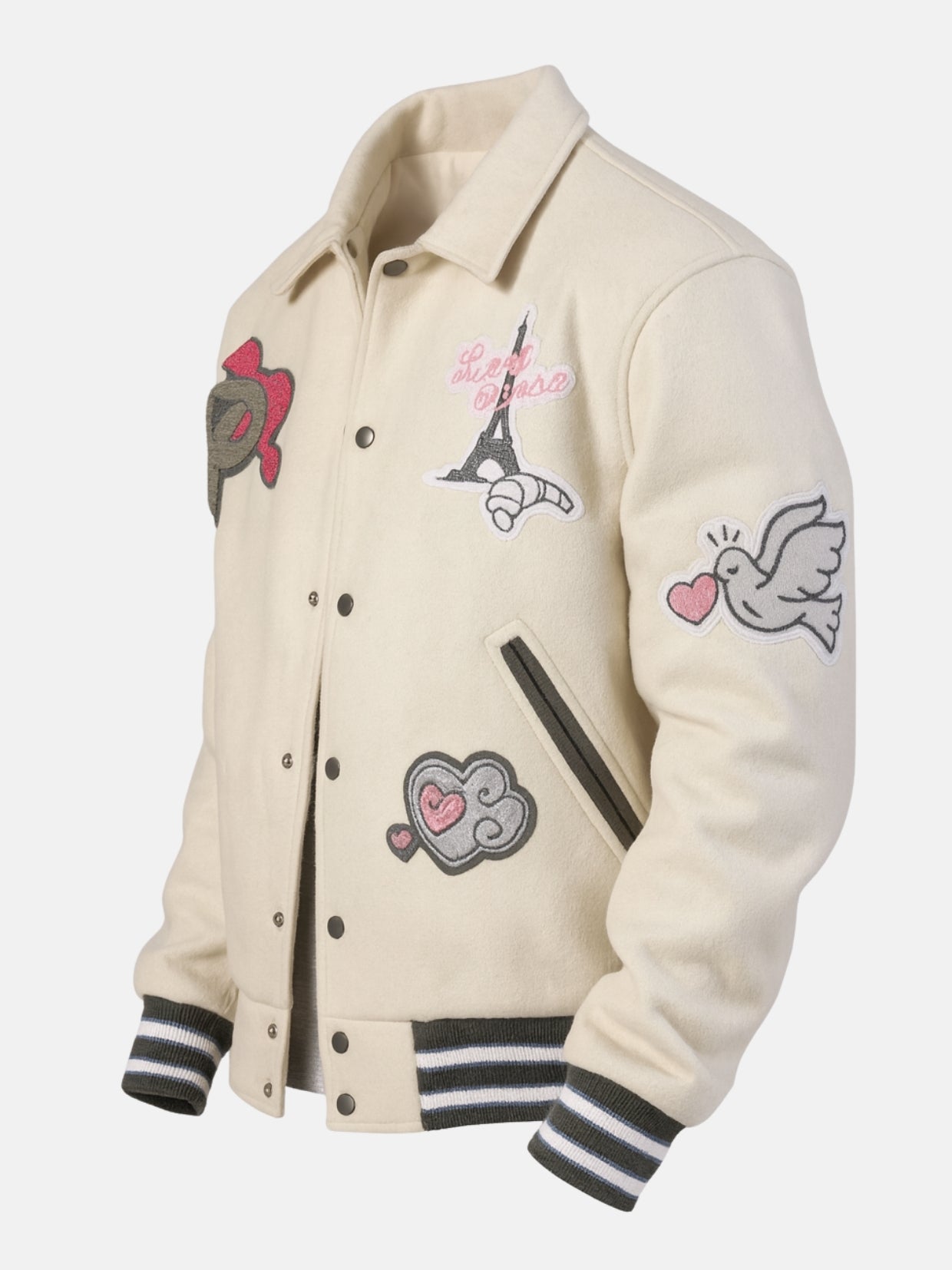 Angled view of cream varsity jacket with embroidered patches and striped ribbing