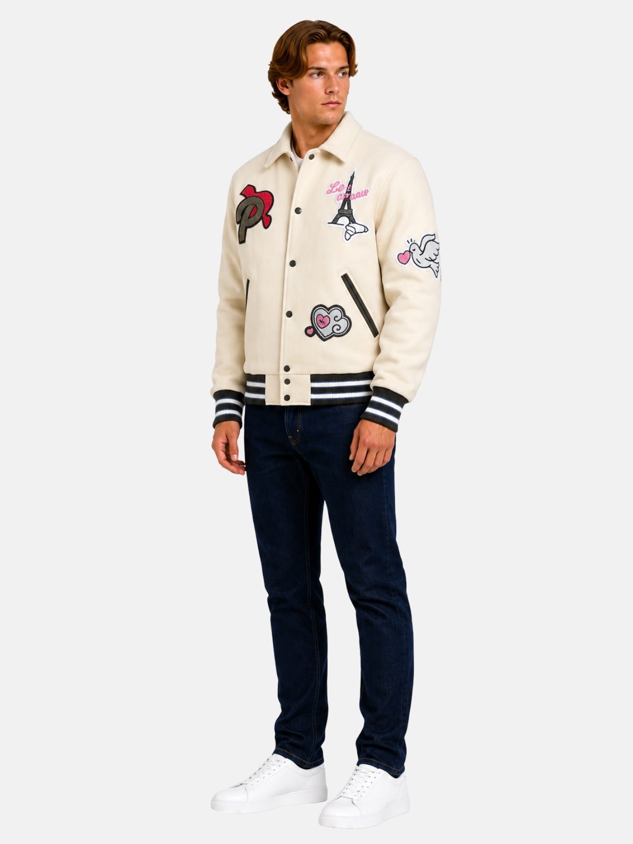 Full-length view of model in cream wool varsity jacket with Eiffel Tower patch