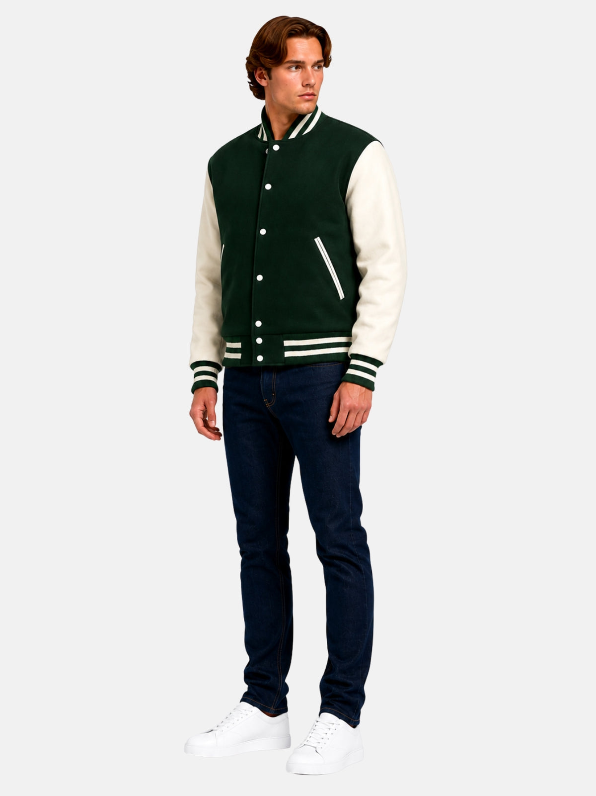 Full-length view of model in dark green wool varsity jacket with dark denim