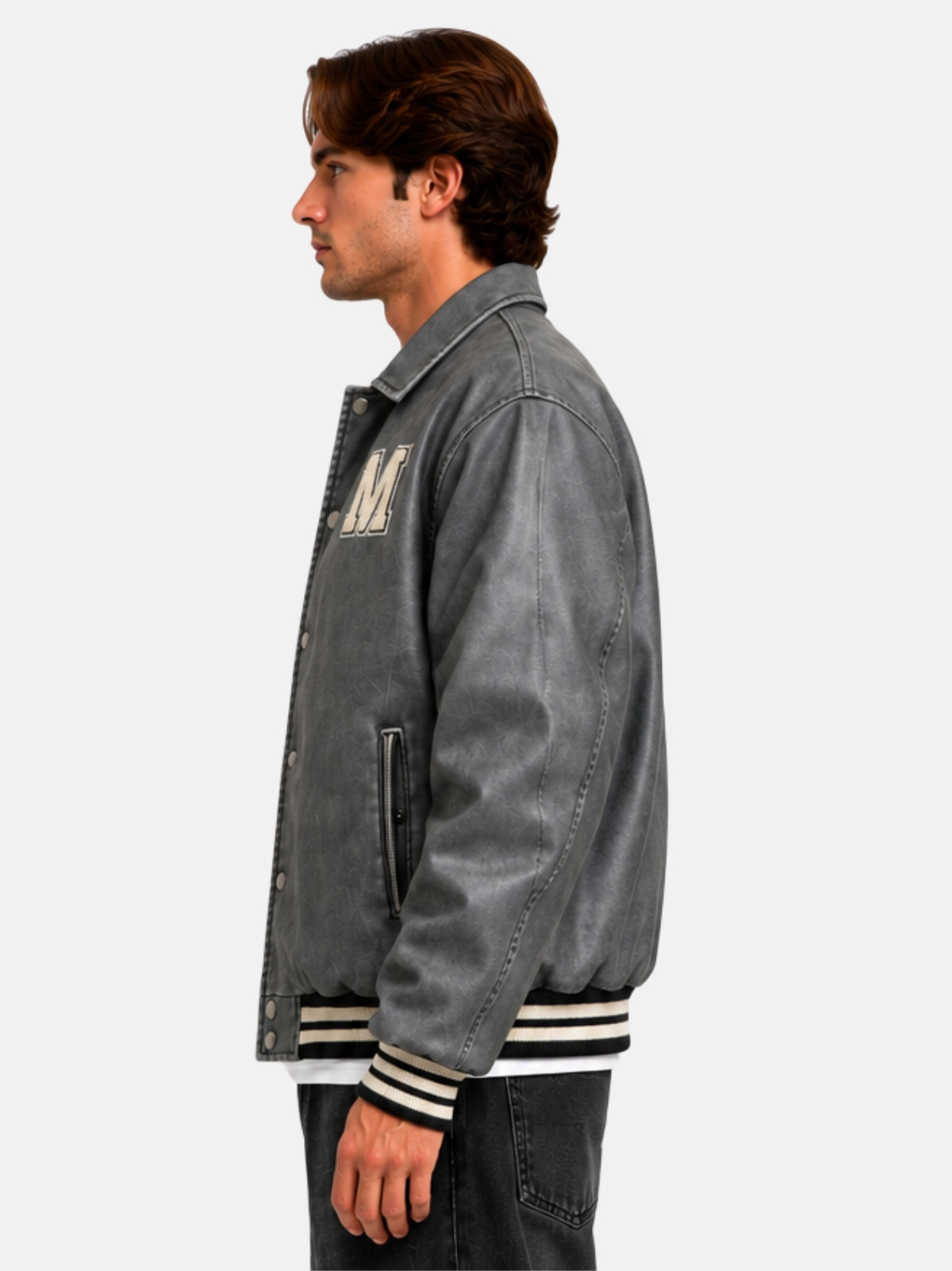 Side profile of a distressed grey leather letterman jacket with striped rib cuffs