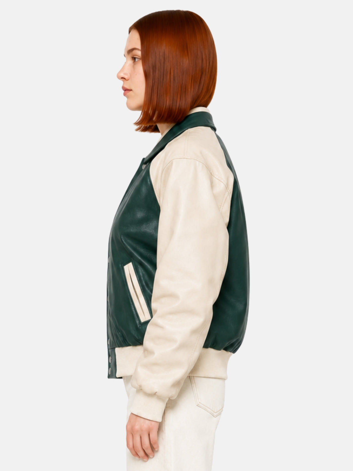 Green and cream women's leather varsity jacket, side profile view, on model