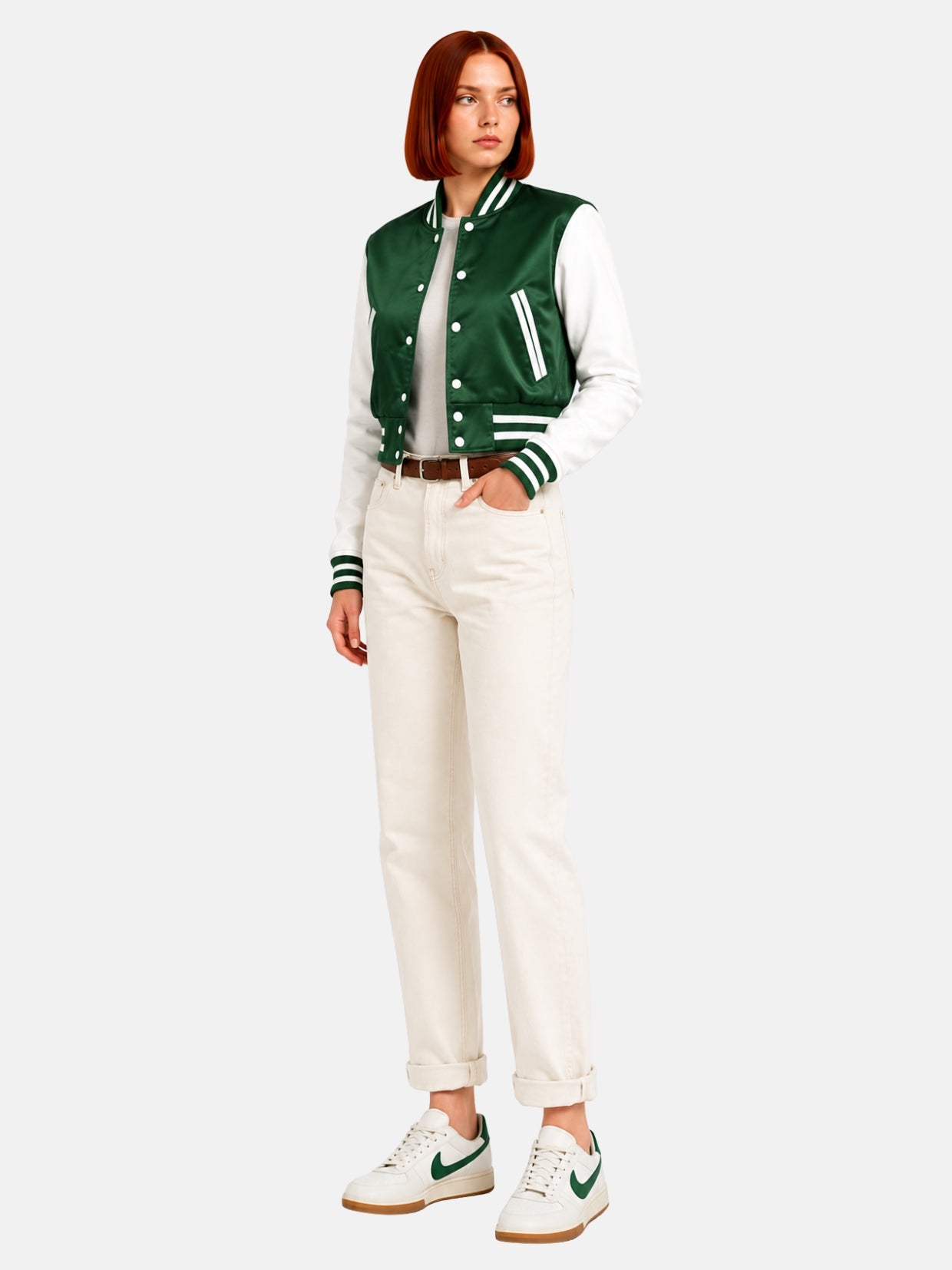 Full-body three-quarter shot of model walking in the green and white satin jacket, white sneakers with green swoosh