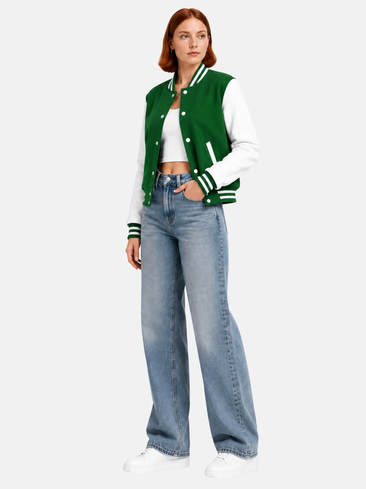 Full-length view of female model in green and white varsity jacket with light-wash denim