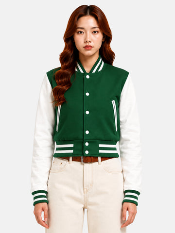 Model in green wool varsity jacket with white leather sleeves, snapped closed over a white crop top