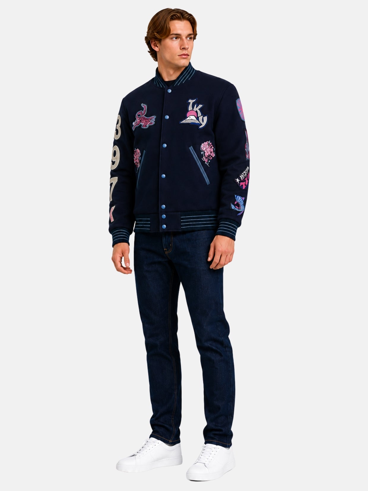 Full-length view of model in navy Japanese varsity jacket with blossom embroidery