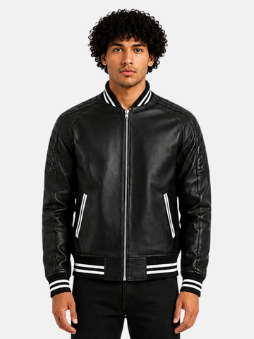 Man wearing black leather varsity bomber jacket with white striped trim and silver zip