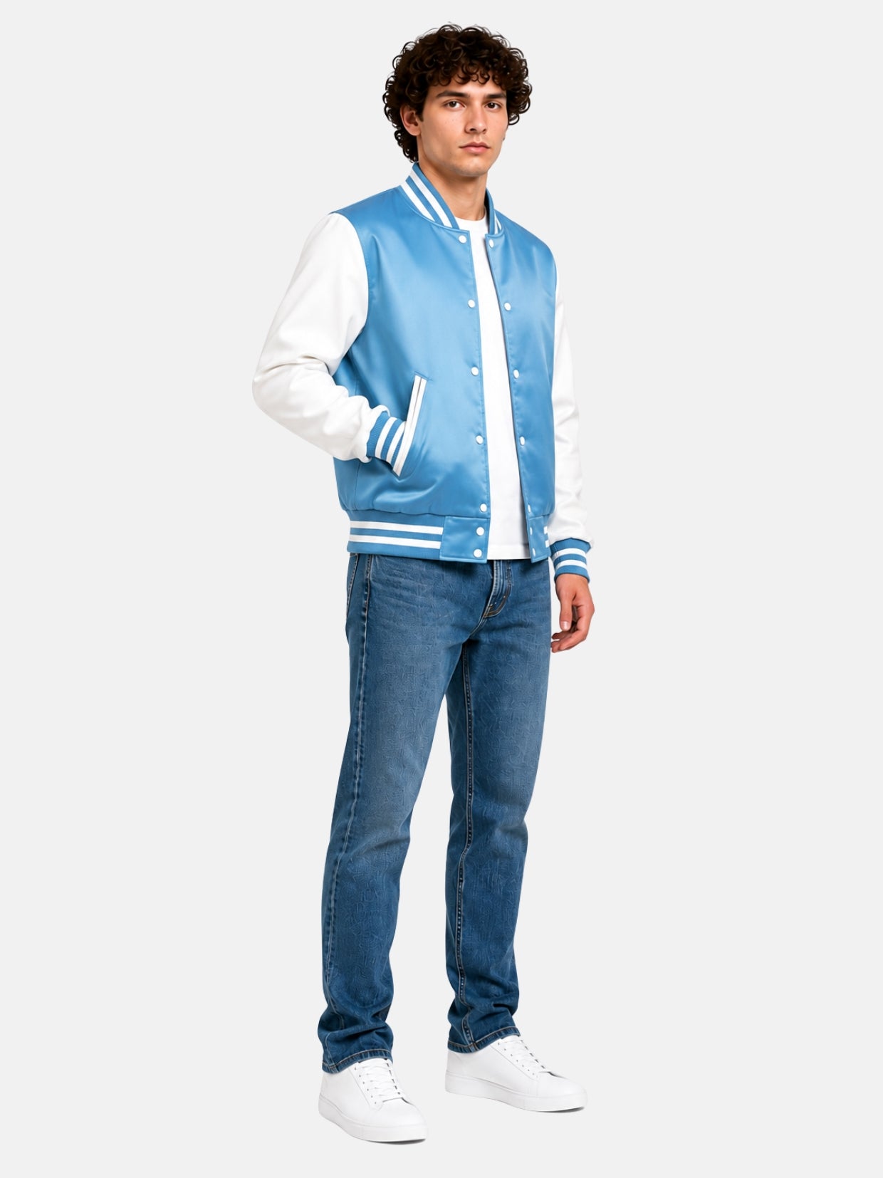 Full-length view of a light blue satin varsity jacket with jeans and white sneakers