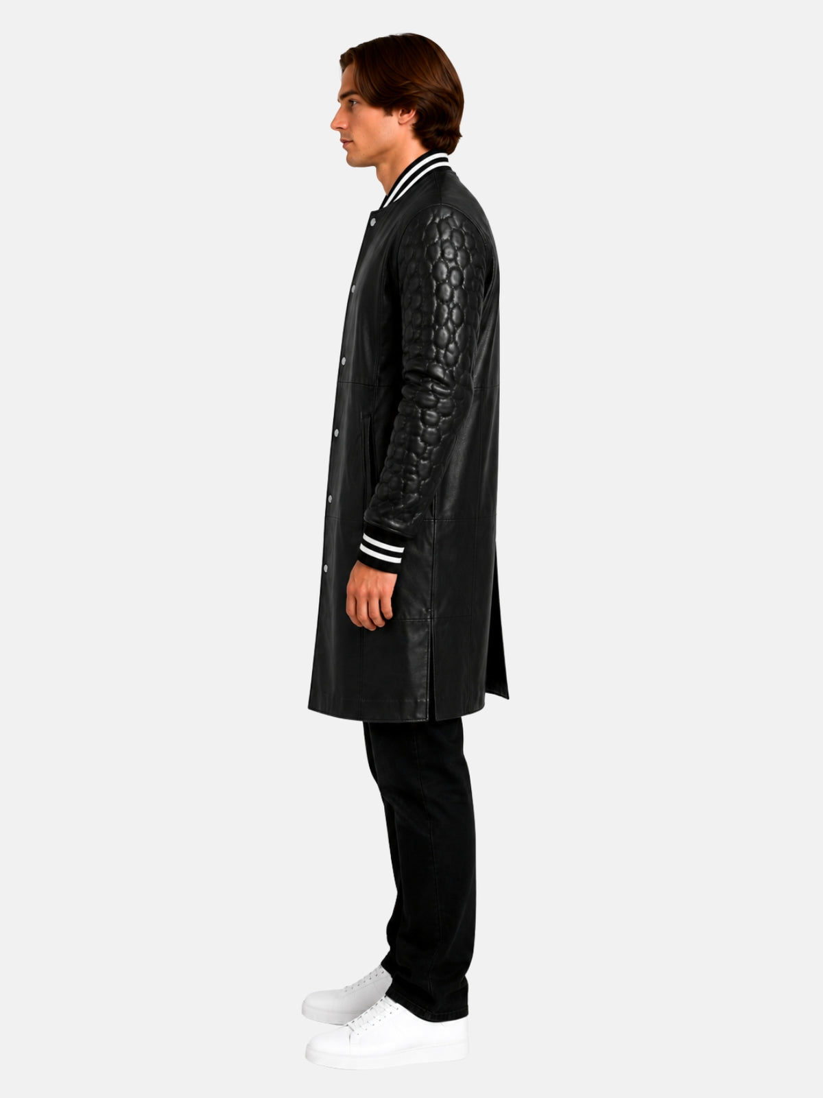 Side profile of longline black varsity coat showing quilted leather sleeve and striped cuff