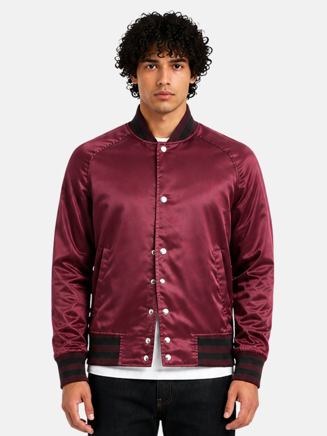 Man wearing a maroon satin varsity jacket with black ribbed trims and silver snaps