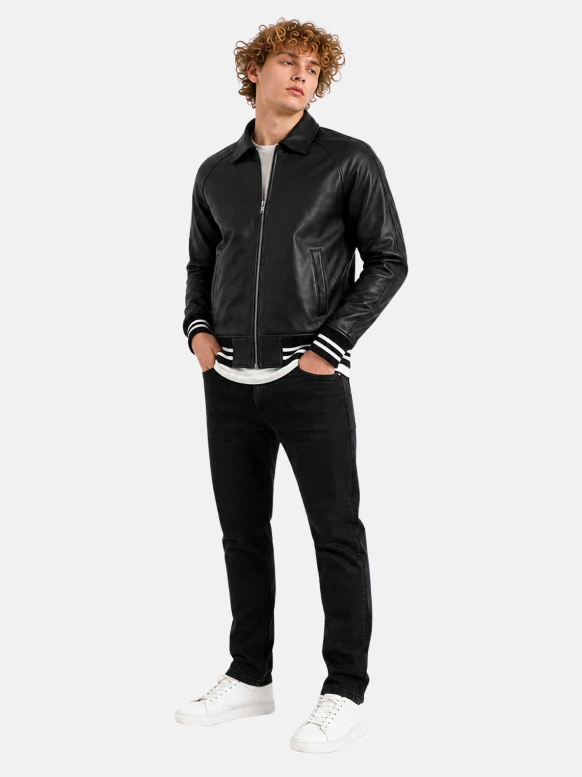 Full-length outfit with minimalist black leather letterman jacket and black denim