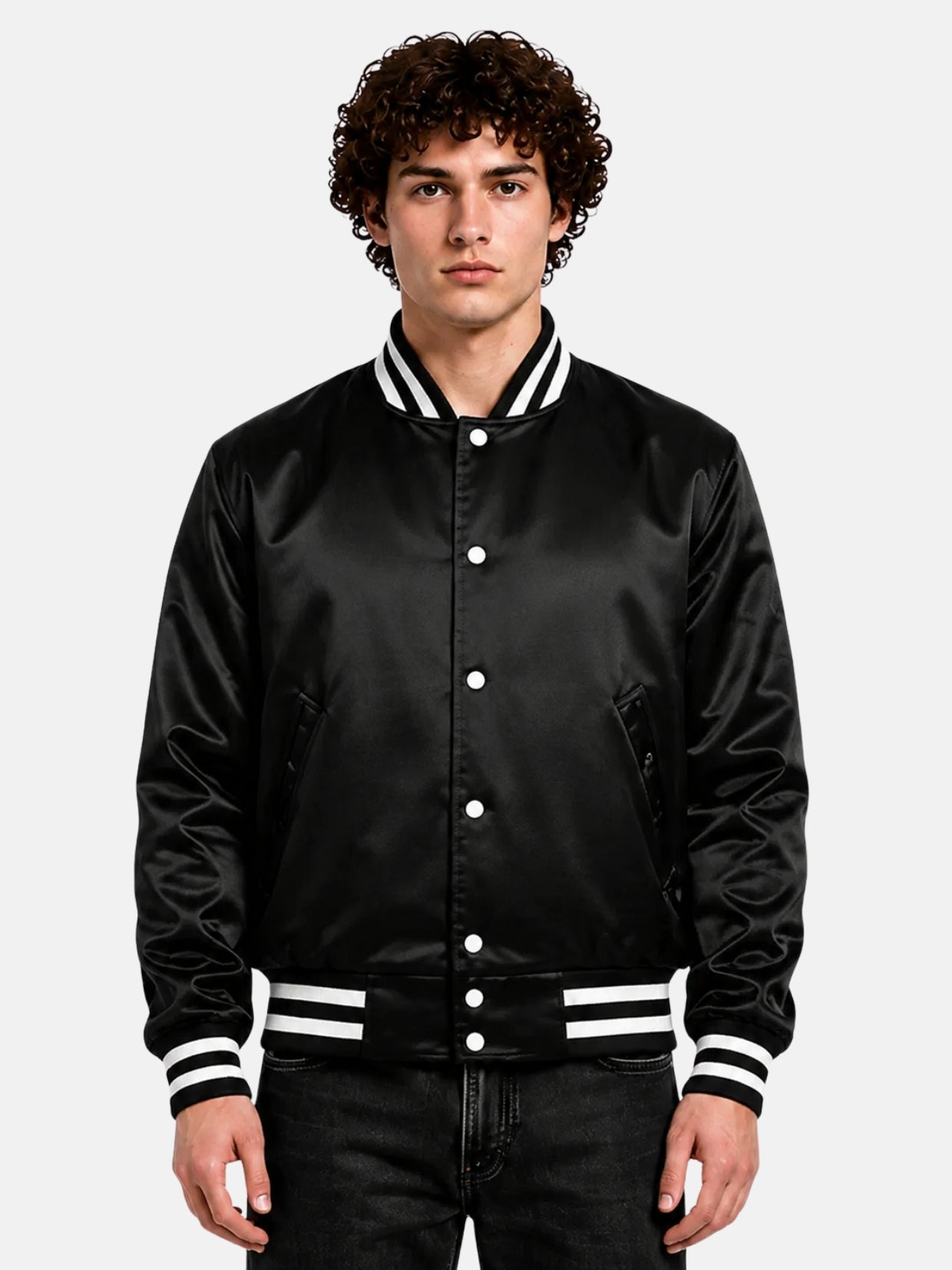 Man wearing a black satin varsity jacket with white pearl snaps and striped rib trims