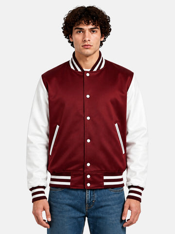 Man wearing a burgundy satin varsity jacket with white sleeves and snap front