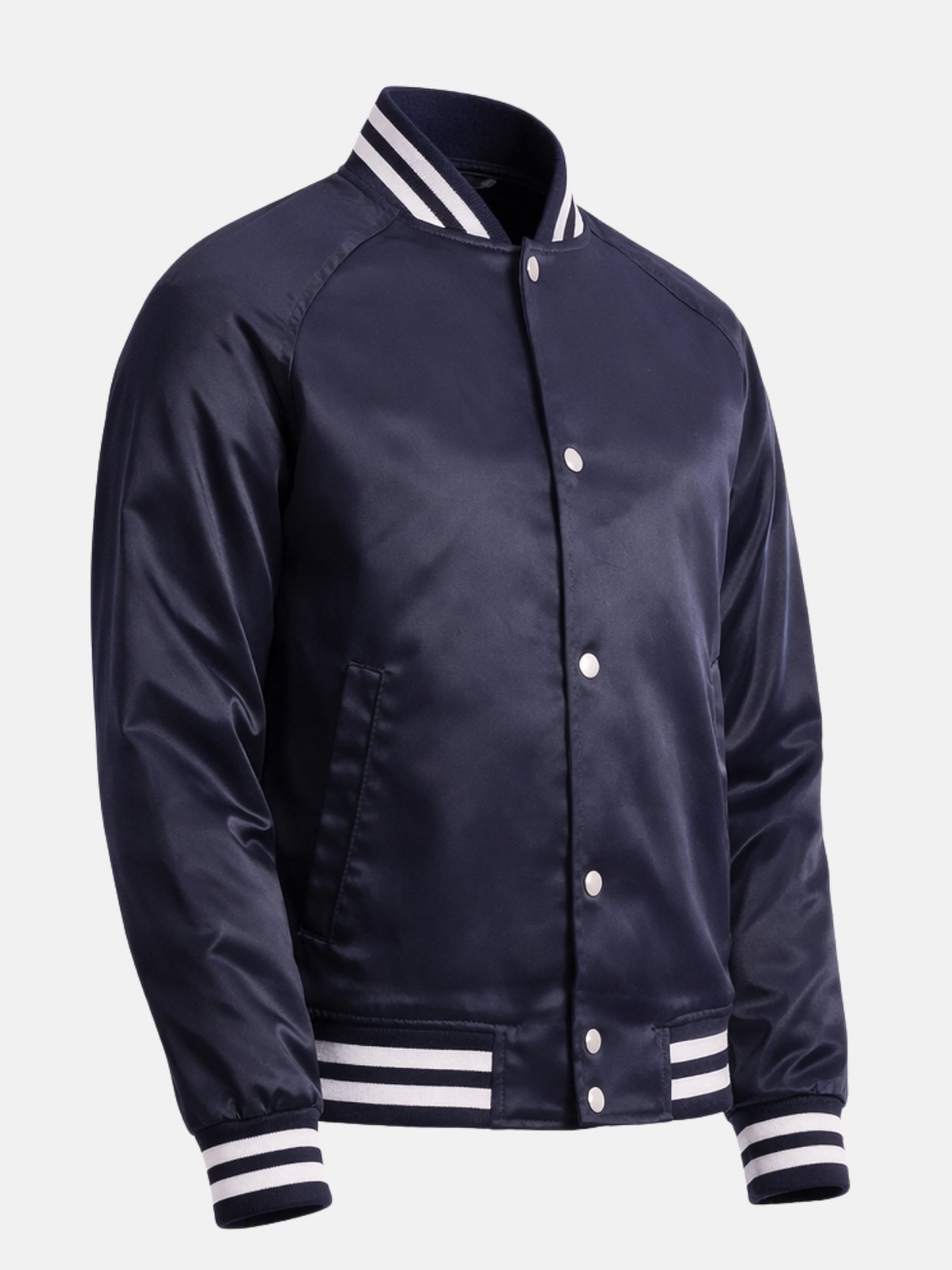 Angled front view of navy bomber-style satin varsity jacket with hem tab snaps