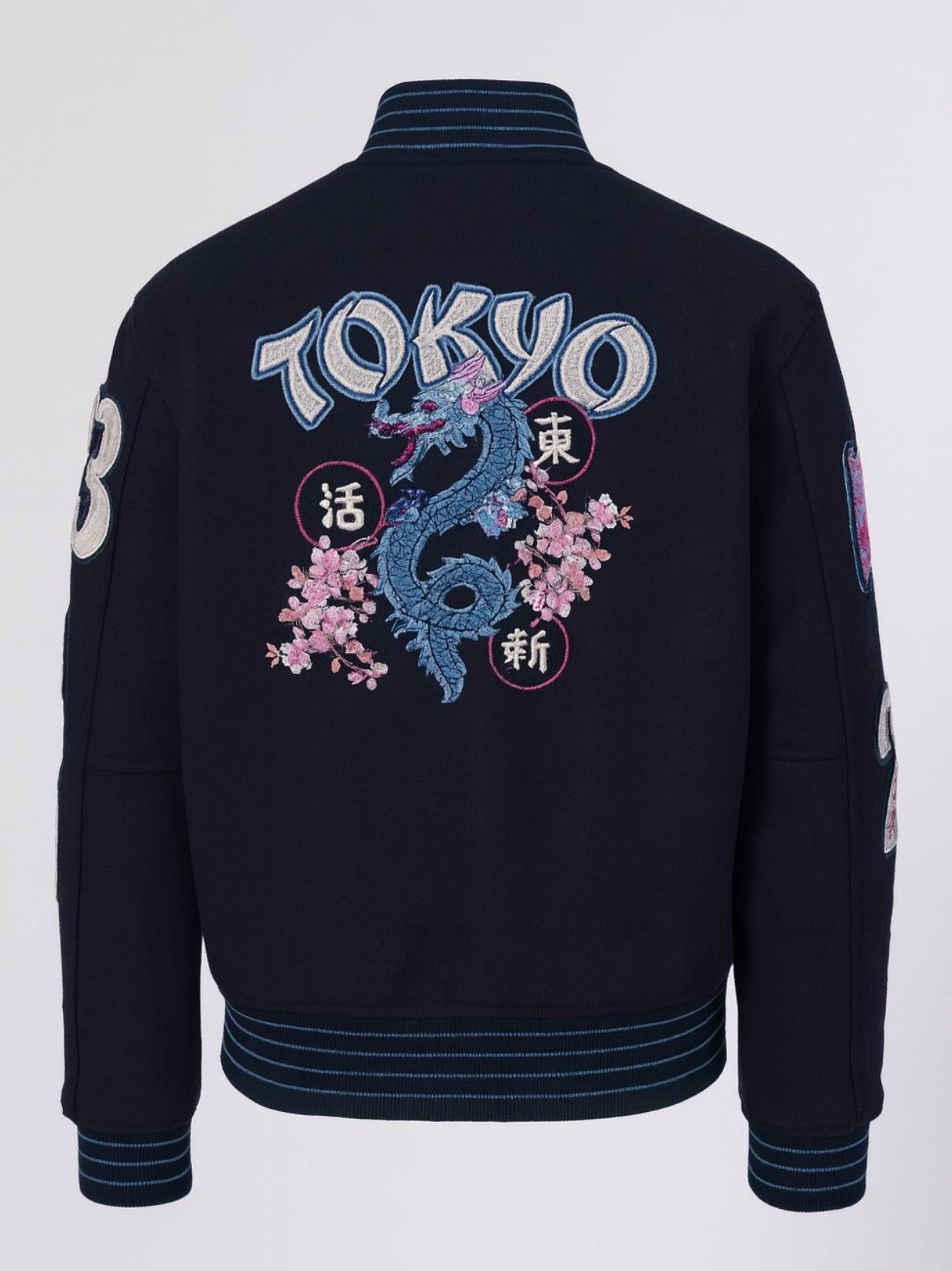 Flat back shot of Tokyo varsity jacket with dragon, kanji seals and blossoms
