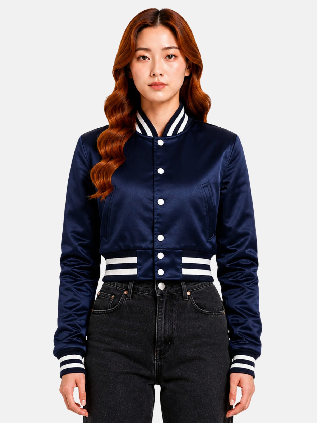 Model in navy satin cropped varsity jacket, top snaps undone over a white crop top