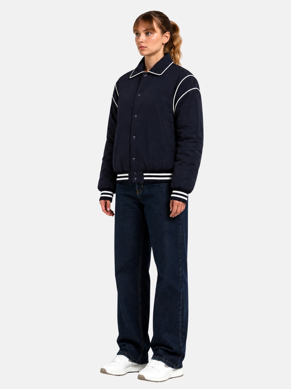 Angled full-body view of oversized navy satin puffer letterman jacket