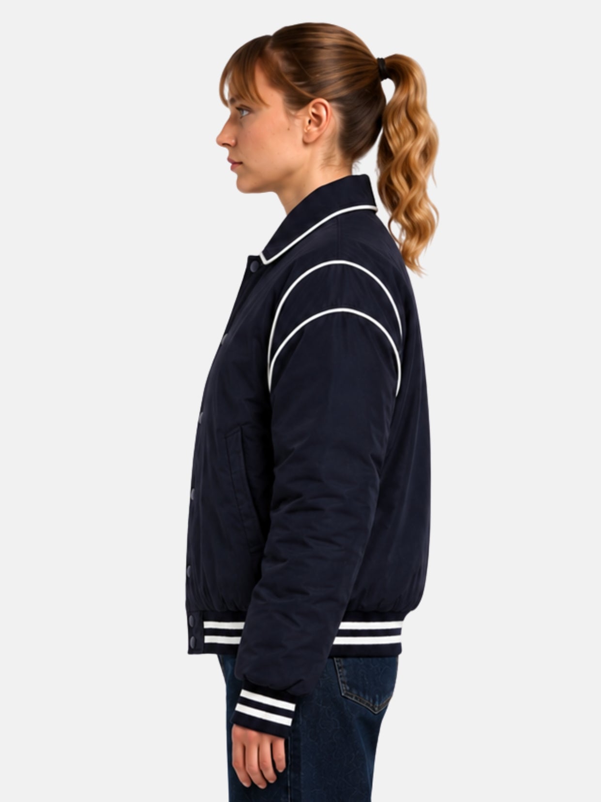 Side profile of navy satin jacket showing curved shoulder piping
