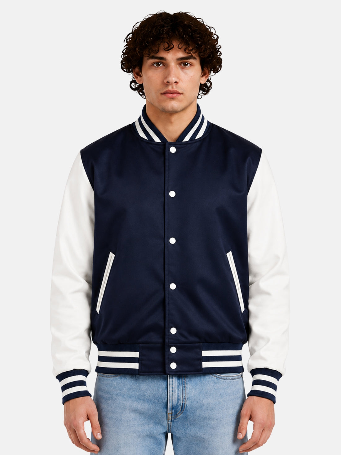 Man wearing a navy satin varsity jacket with white sleeves and striped rib trims, front view