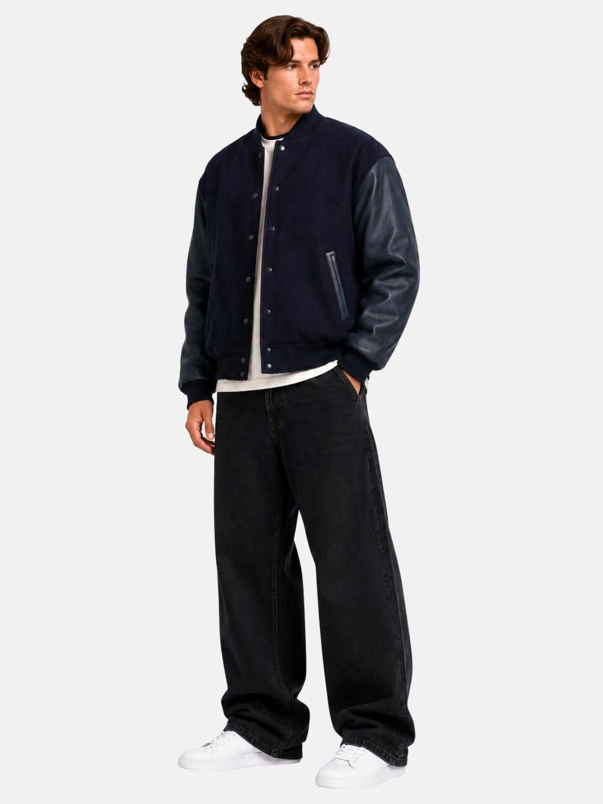 Full-length view of a navy oversized varsity jacket with black jeans and white sneakers