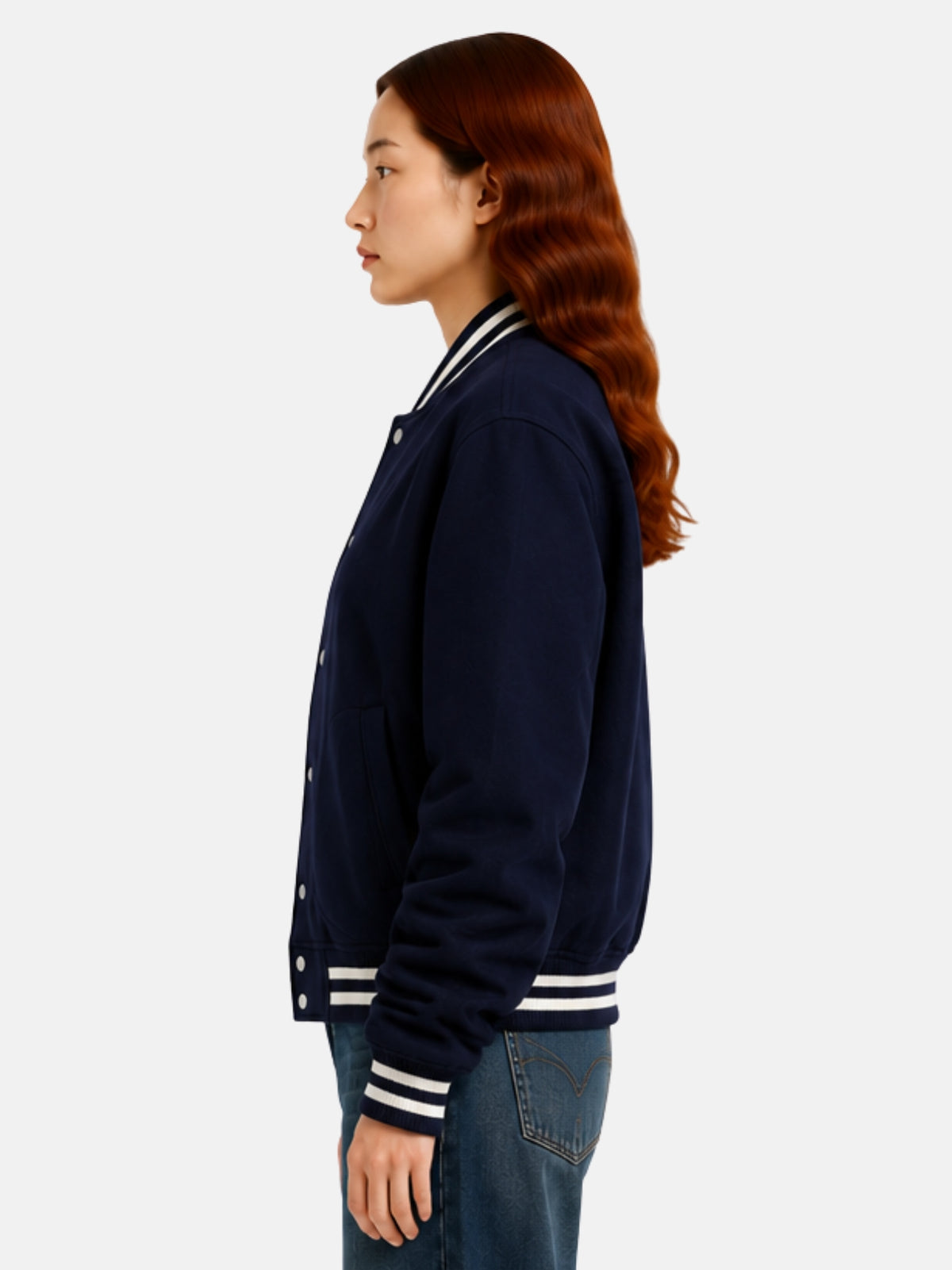 Side profile of navy wool jacket showing curved welt pocket and cream cuff