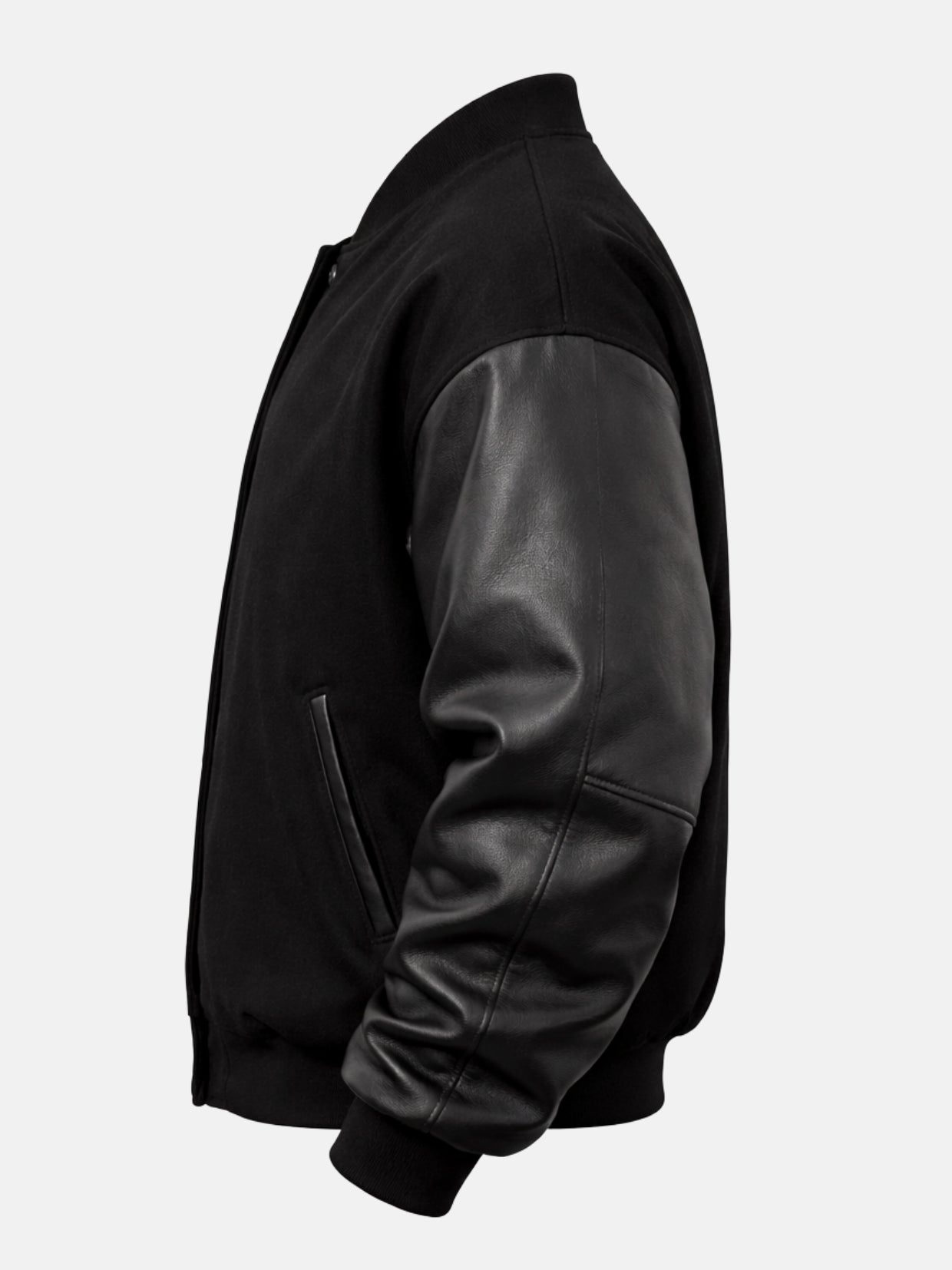 Reverse side view of an oversized black letterman jacket with wool body and leather sleeves