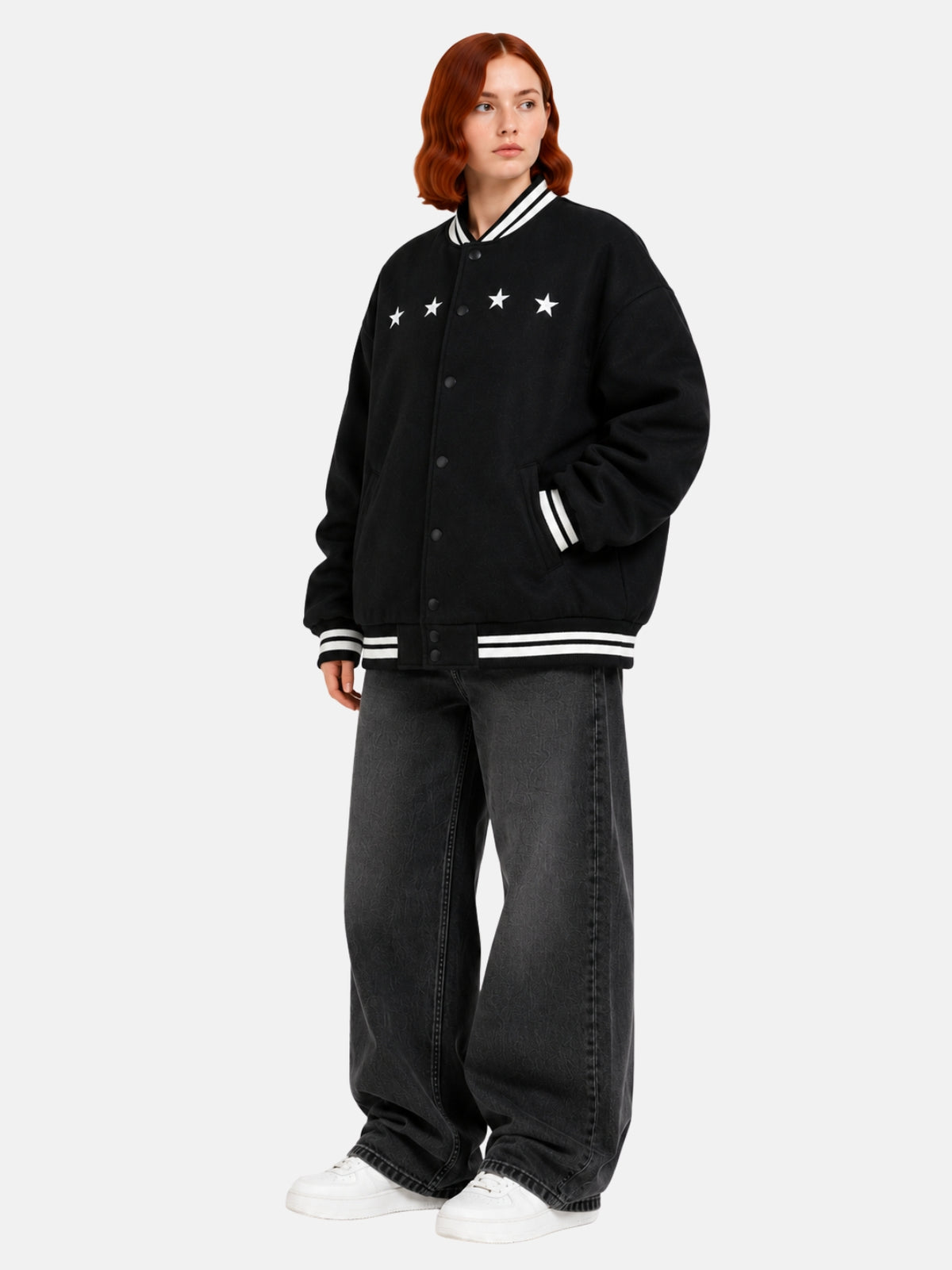Angled full-body view of oversized black varsity jacket with dropped-shoulder cut
