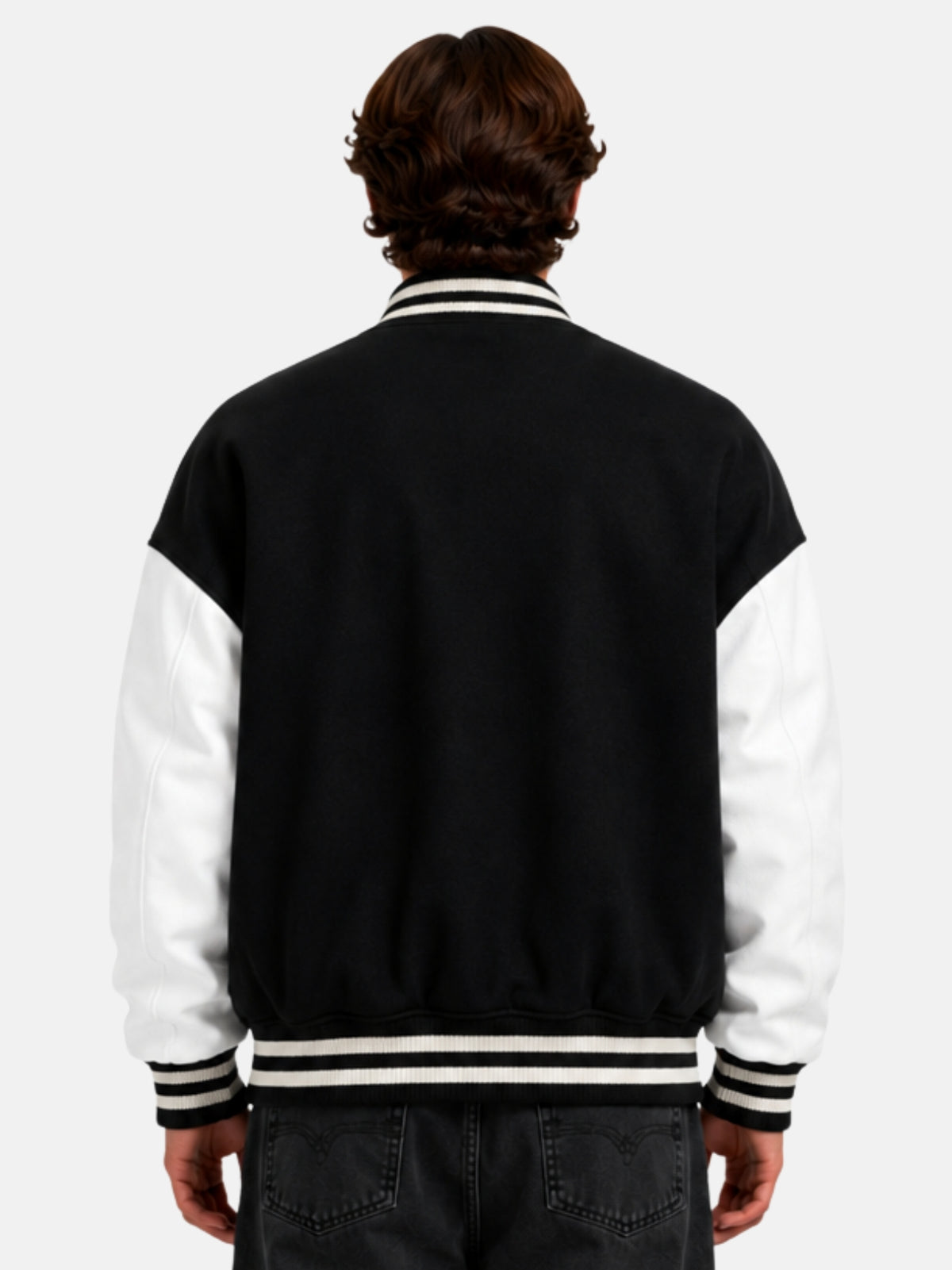 Back view of oversized black wool varsity jacket with white sleeves on model
