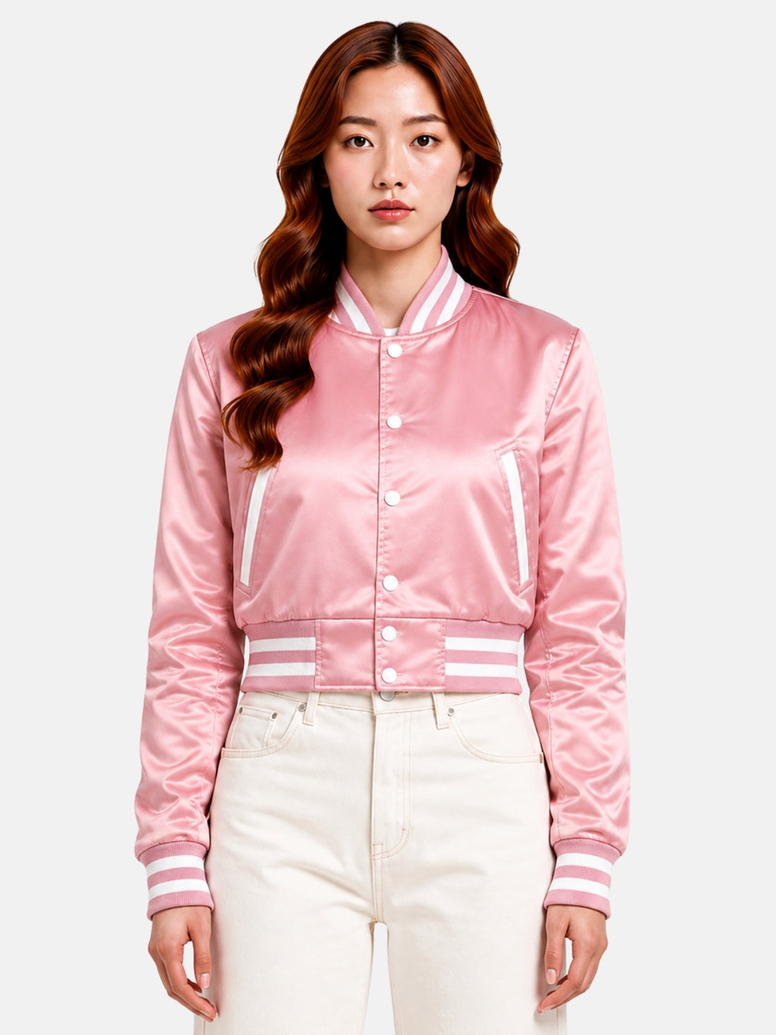 Model in pink satin varsity jacket, top snaps open over a white crop top