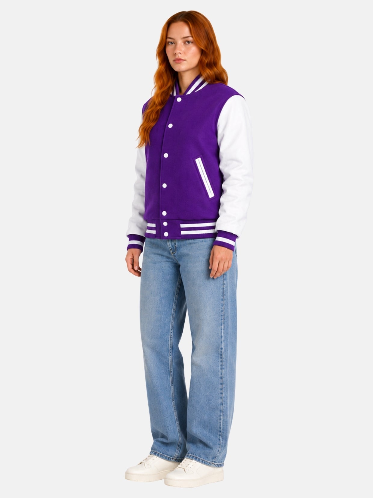 Full-length view of female model in purple and white varsity jacket with light-wash denim