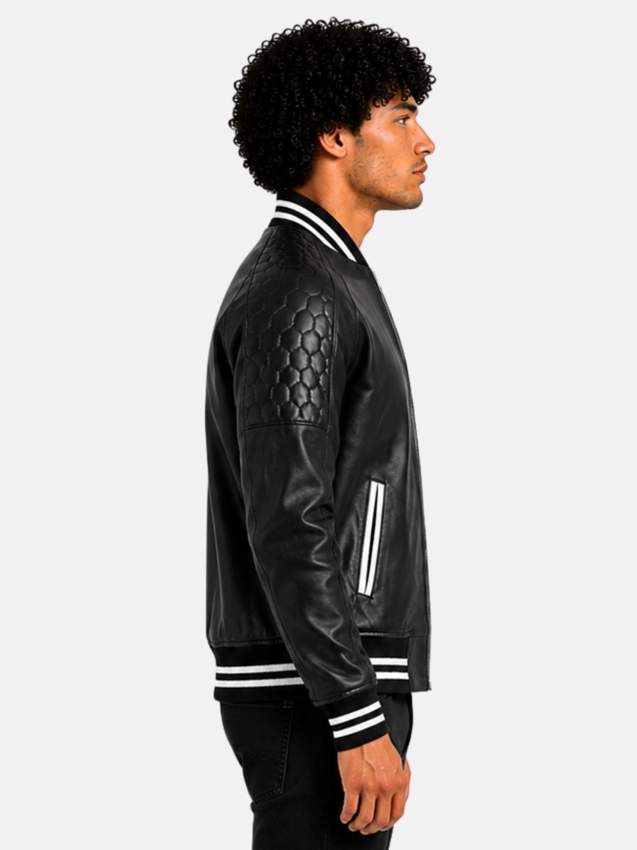 Side profile showing honeycomb quilted shoulder on black leather varsity jacket