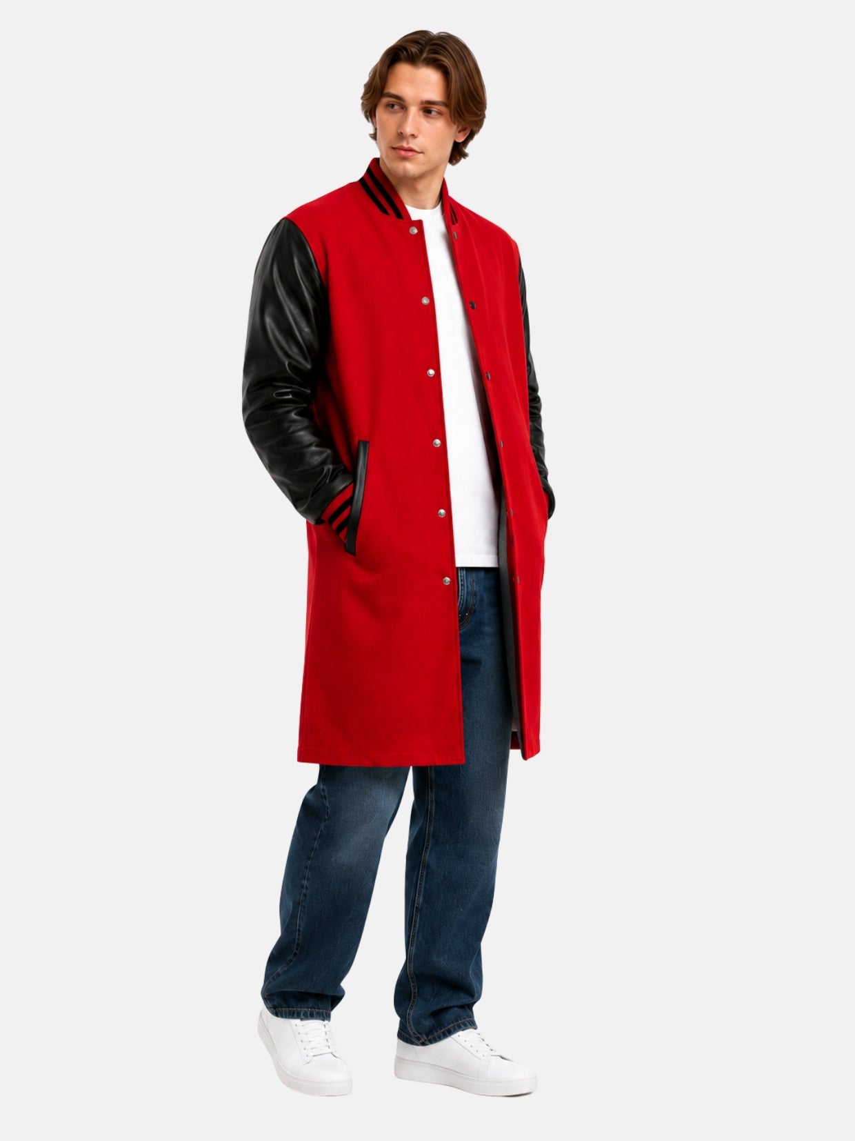 Model in long red letterman coat with black leather sleeves over blue jeans