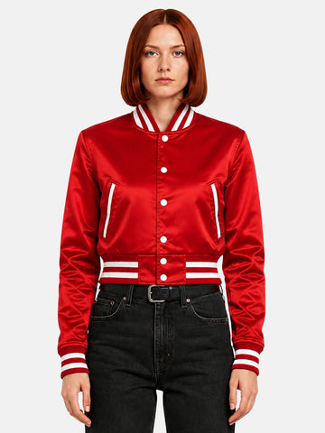Model wearing the red satin varsity jacket snapped to the neck, white ribbed collar stripe framing the face