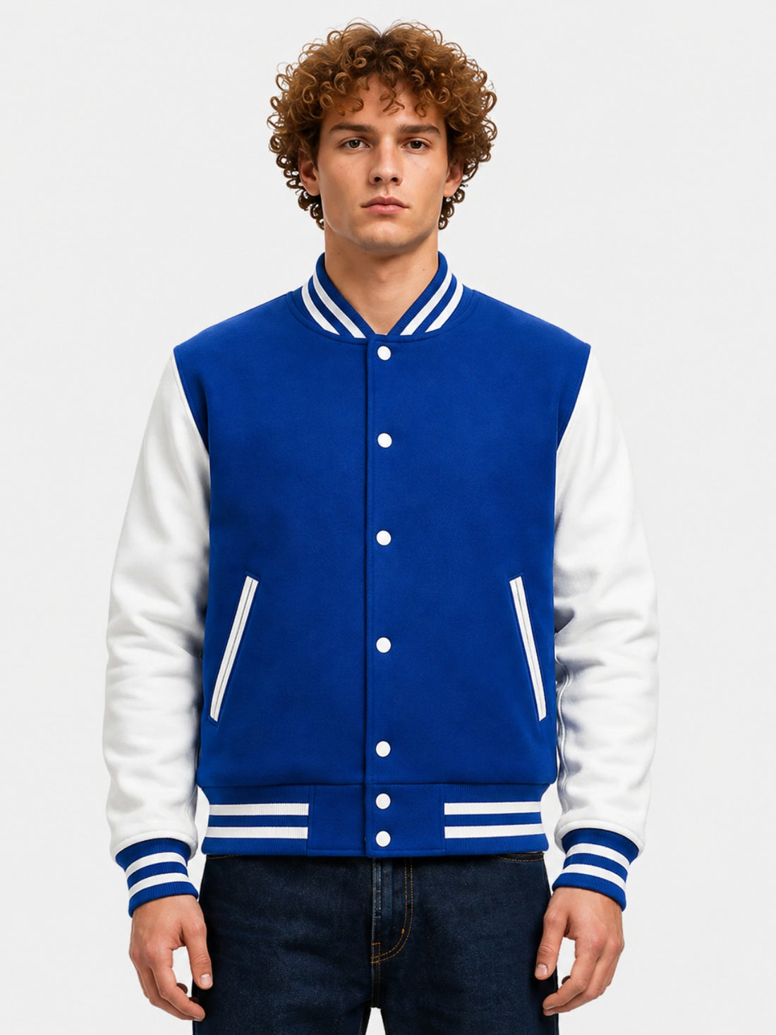 Man wearing royal blue varsity jacket with white leather sleeves and striped rib collar, front view