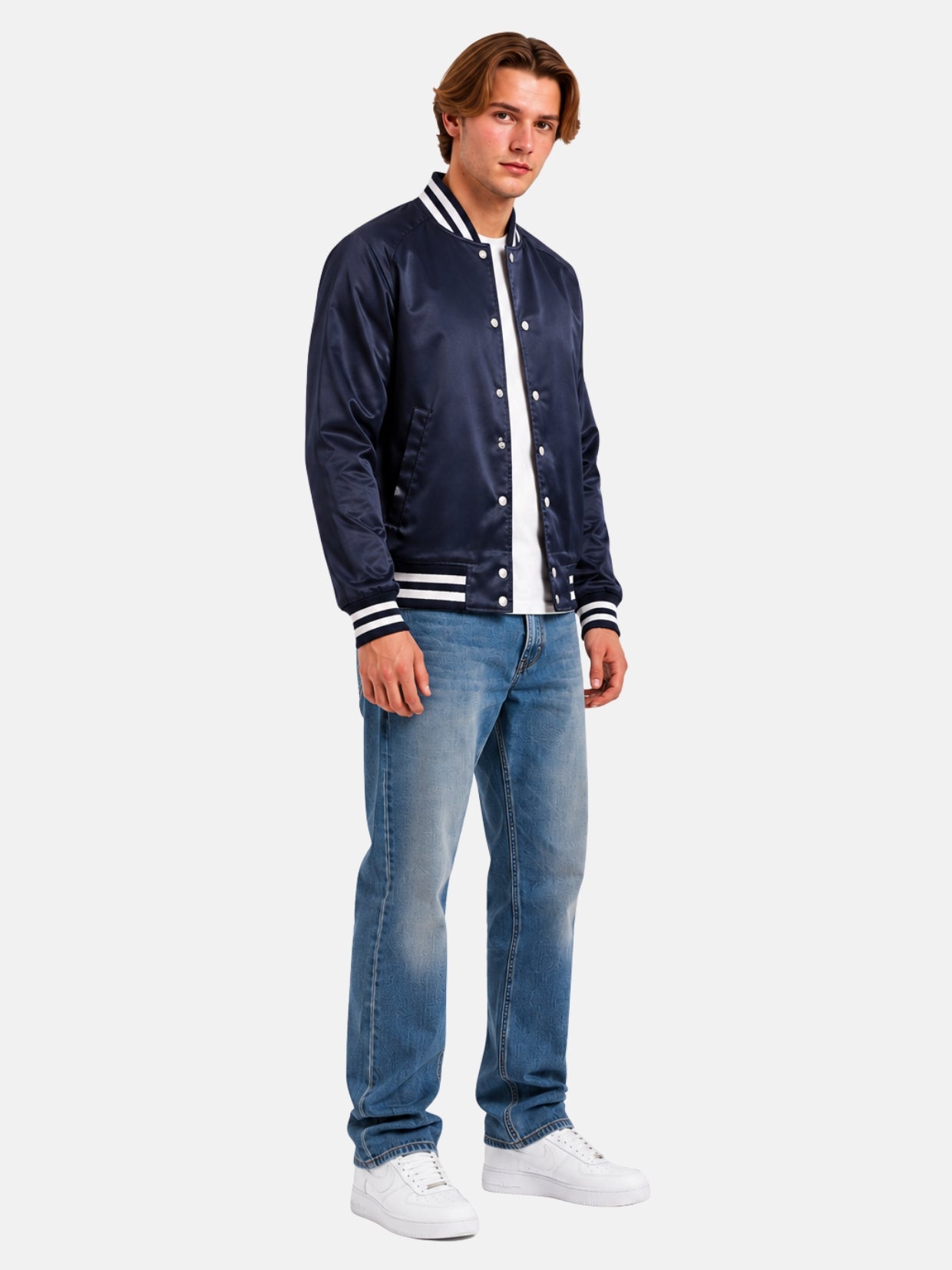 Full-length view of model in tonal navy satin varsity bomber jacket with jeans