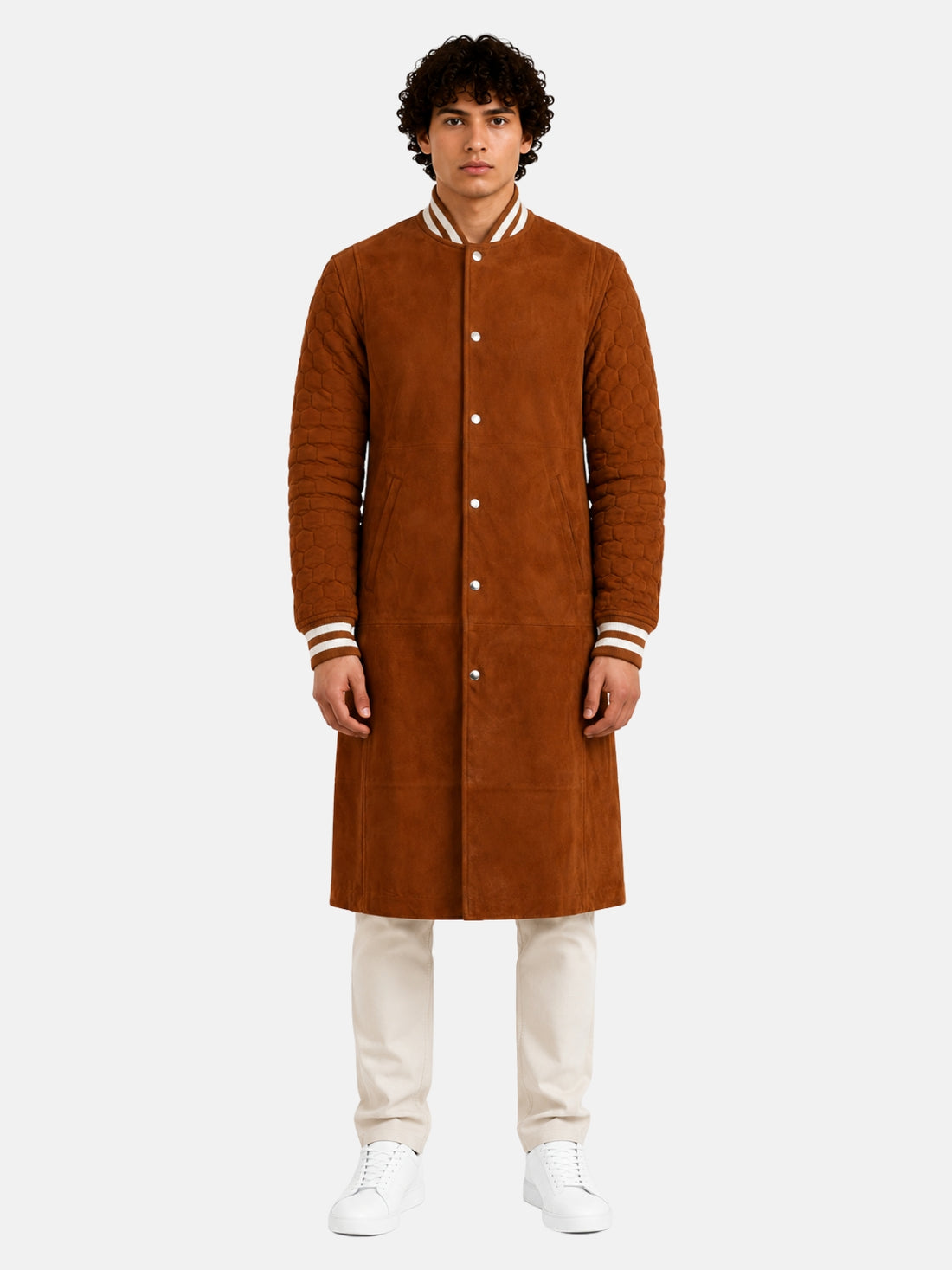 Man wearing knee-length tan suede varsity coat with quilted sleeves and striped rib collar