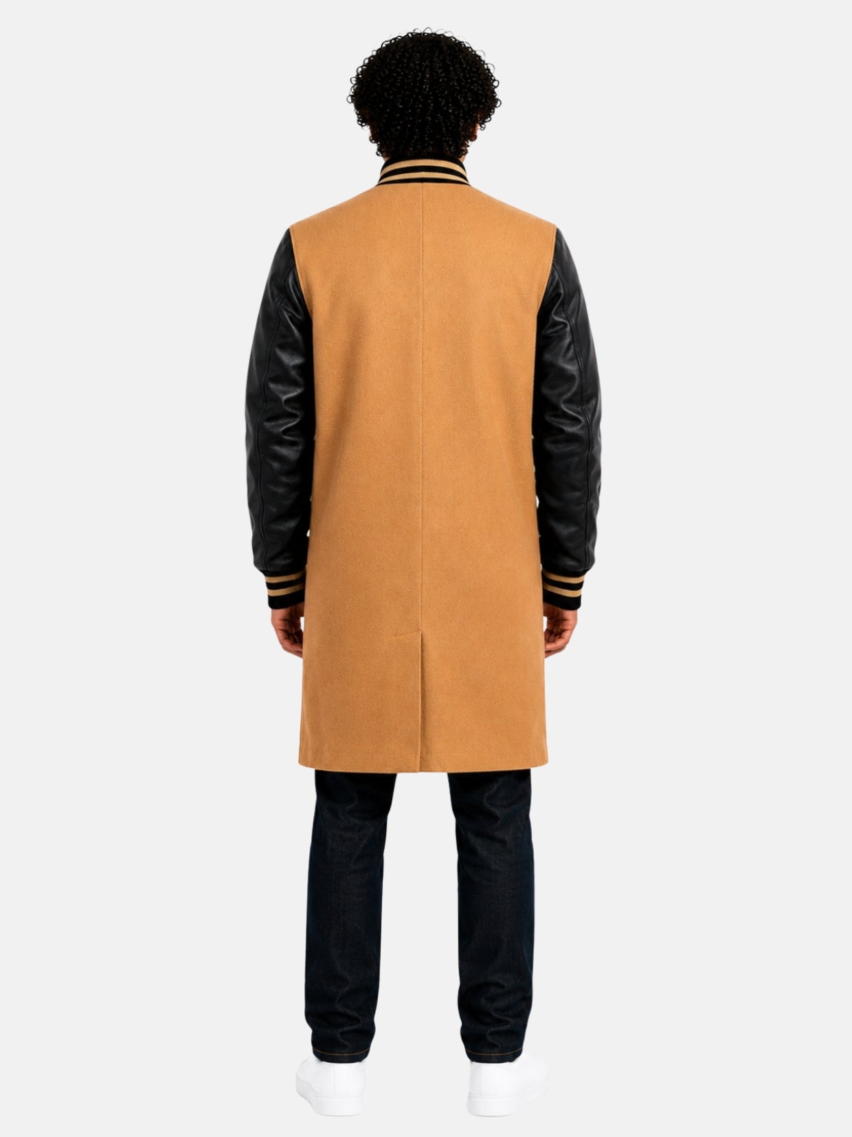 Back view of tan wool varsity trench coat with black leather sleeves on model