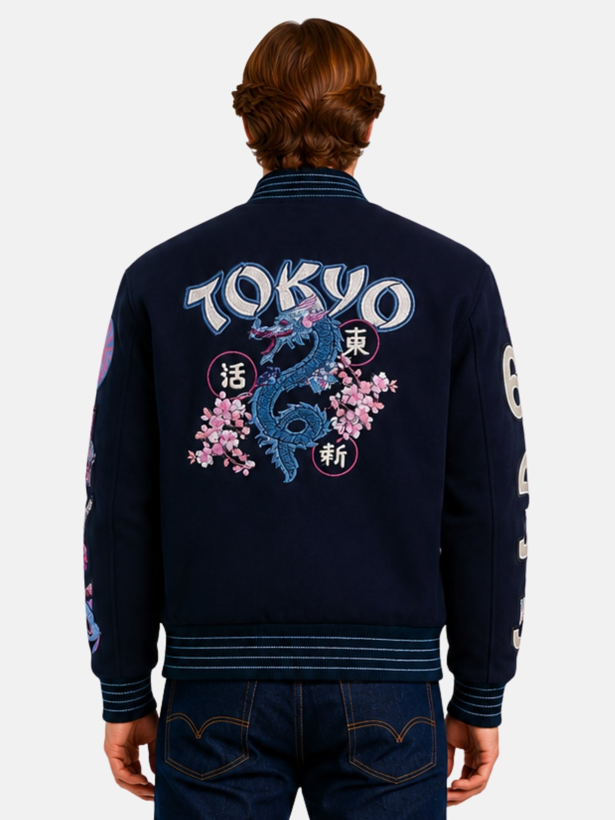 Back view of navy varsity jacket with Tokyo dragon and cherry blossom embroidery