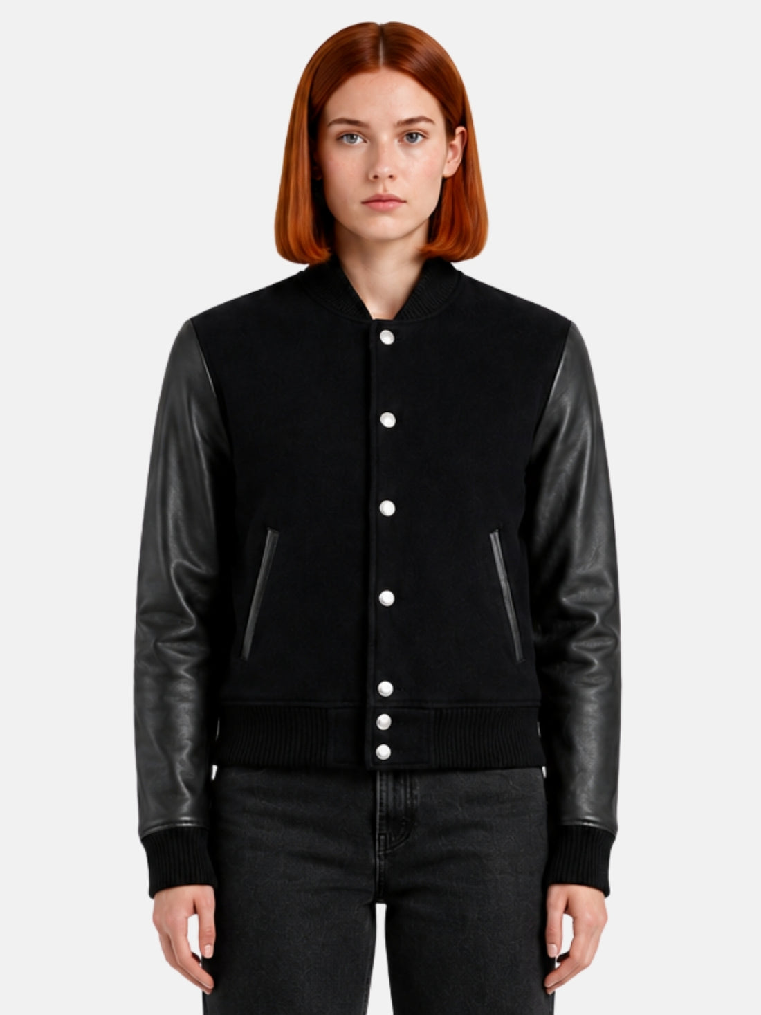Woman wearing a triple black varsity jacket with tonal leather sleeves and matte snaps