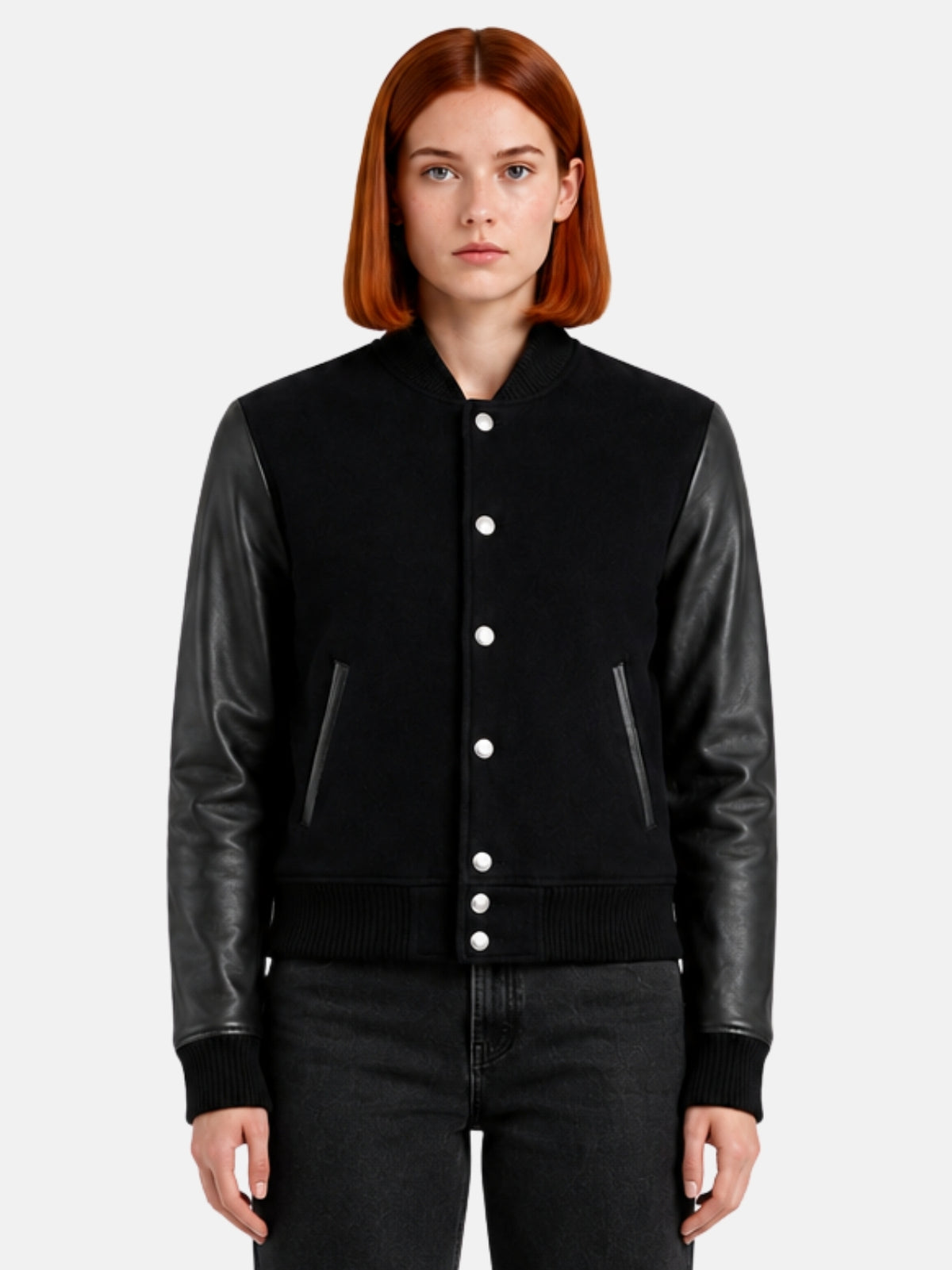 Woman wearing a triple black varsity jacket with tonal leather sleeves and matte snaps