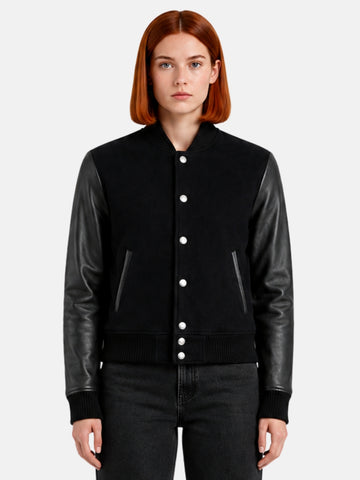 Woman wearing a triple black varsity jacket with tonal leather sleeves and matte snaps