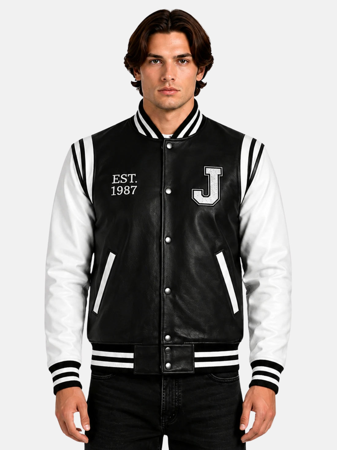 Man wearing black and white leather letterman jacket with chenille J patch and Est 1987 embroidery
