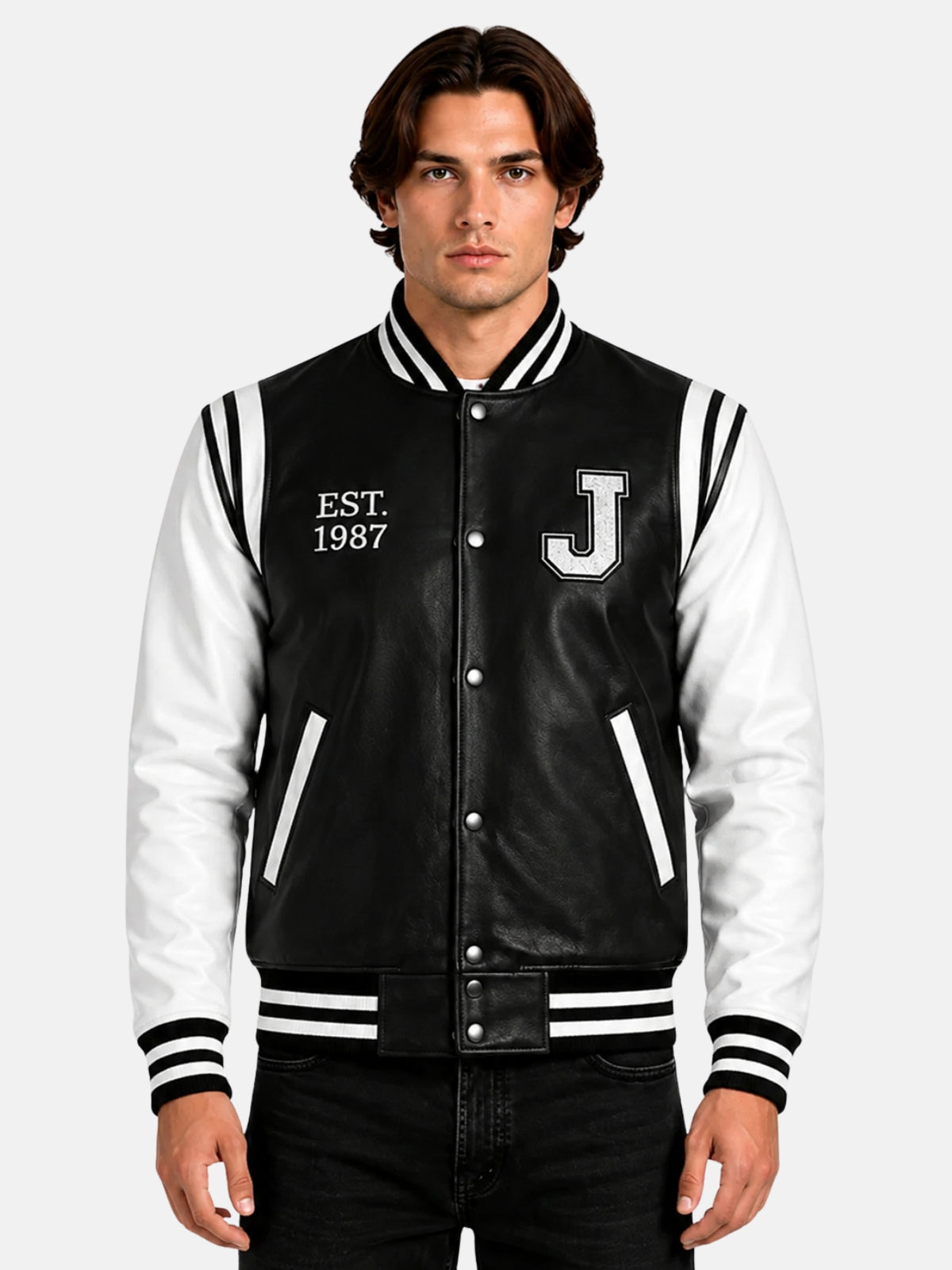 Man wearing black and white leather letterman jacket with chenille J patch and Est 1987 embroidery